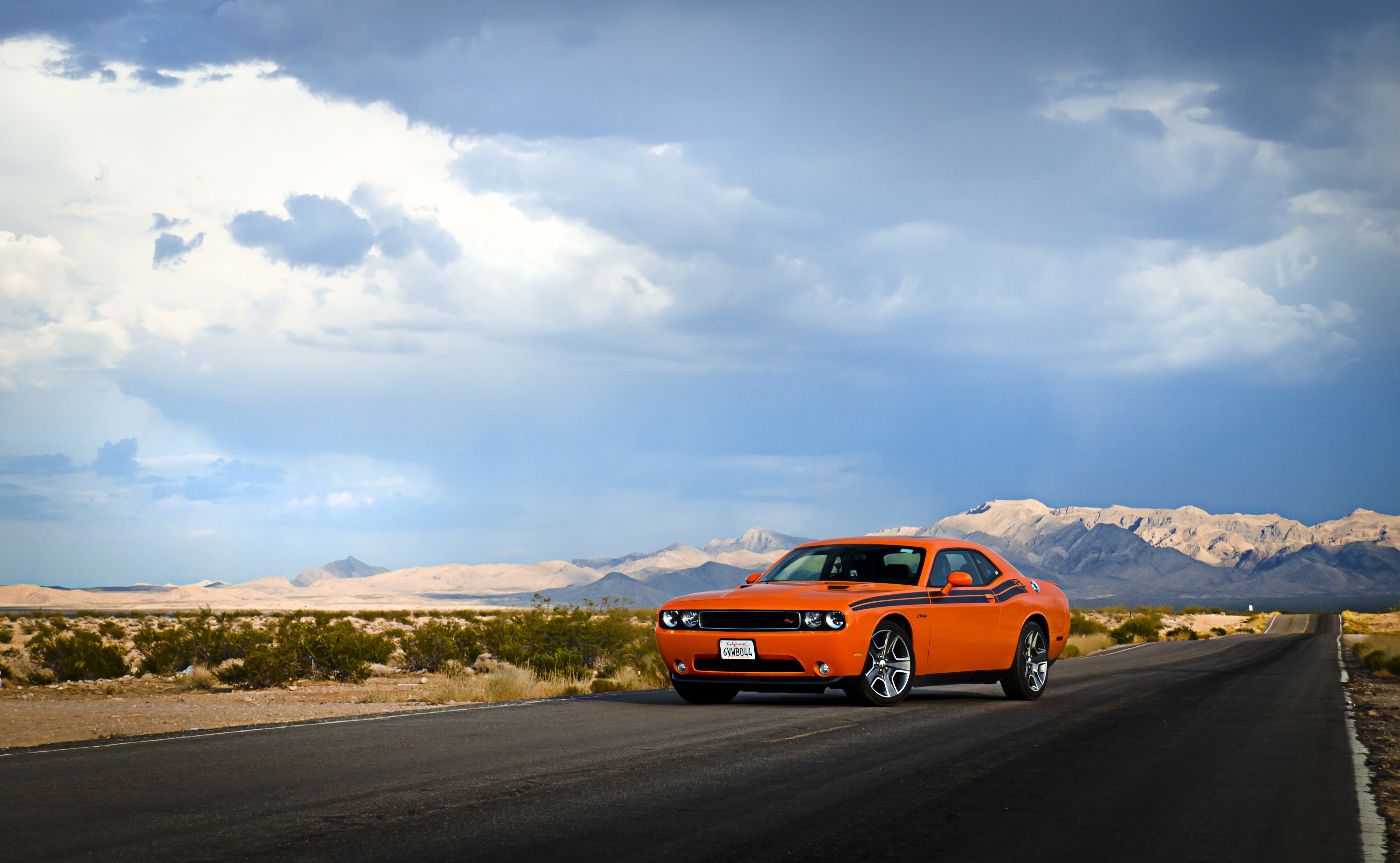 4K Orange Dodge Challenger on Desert Road HD Wallpaper