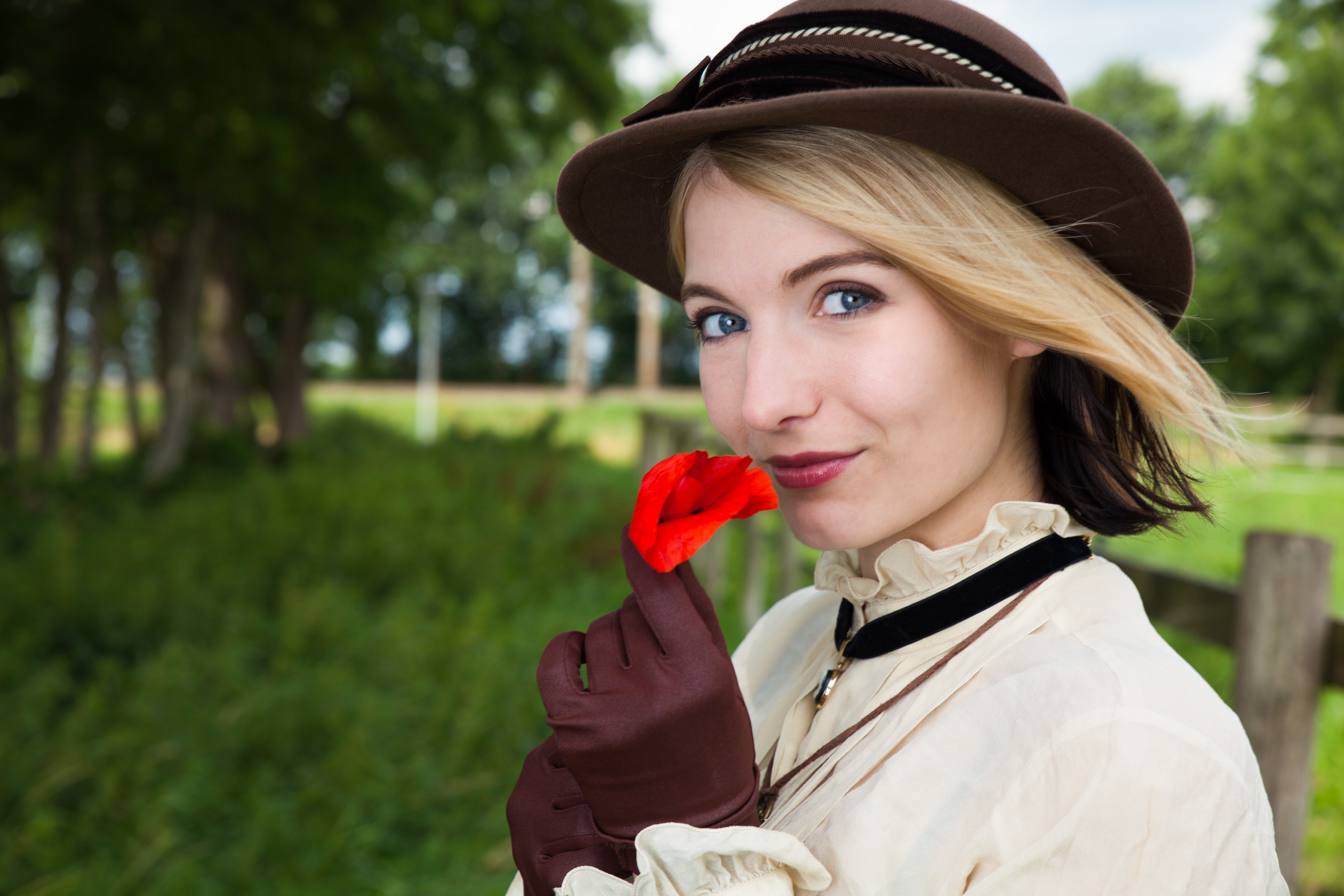 Blonde girl in a hat holding a red flower HD Wallpaper