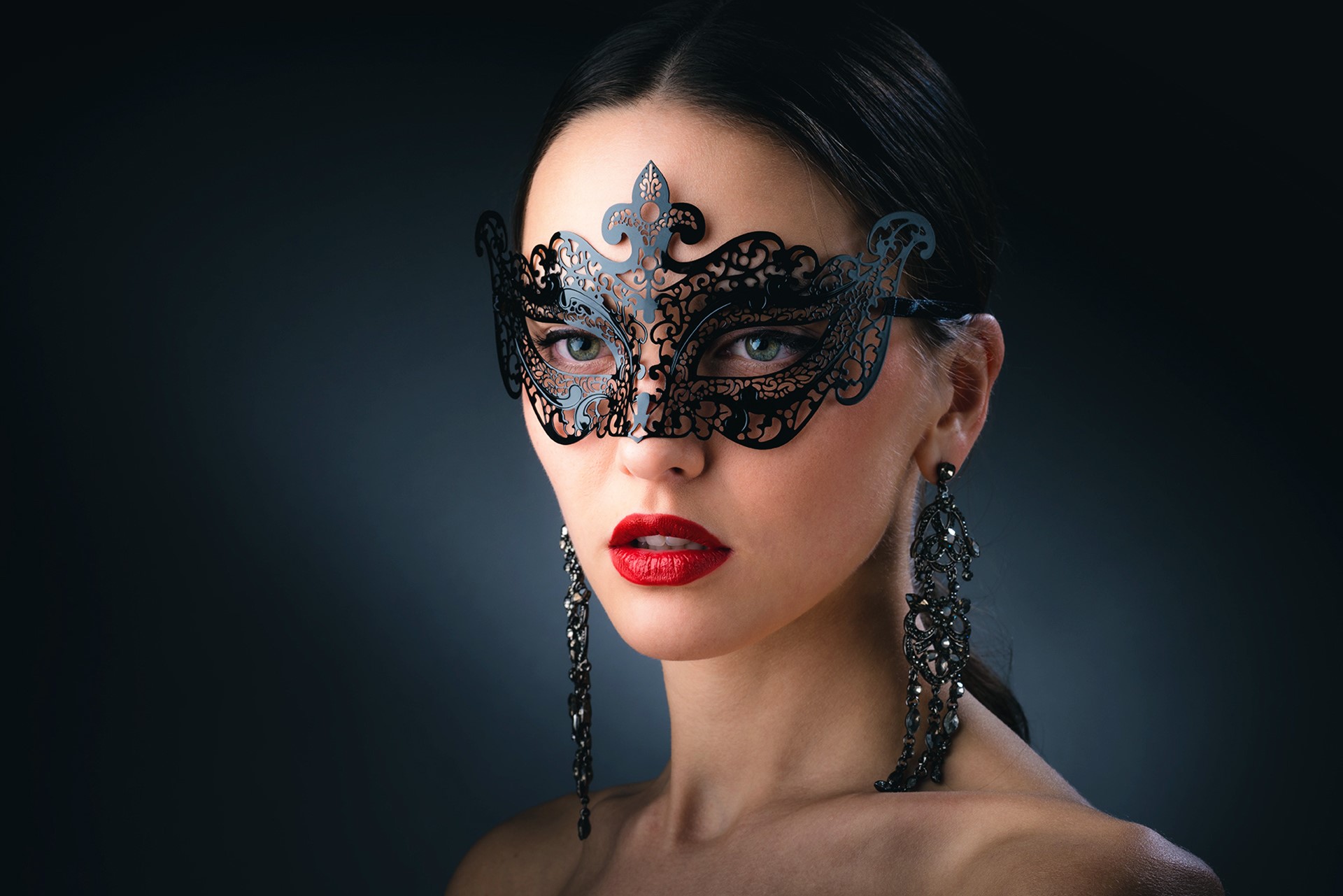 Woman wearing a black masquerade mask and earrings HD Wallpaper