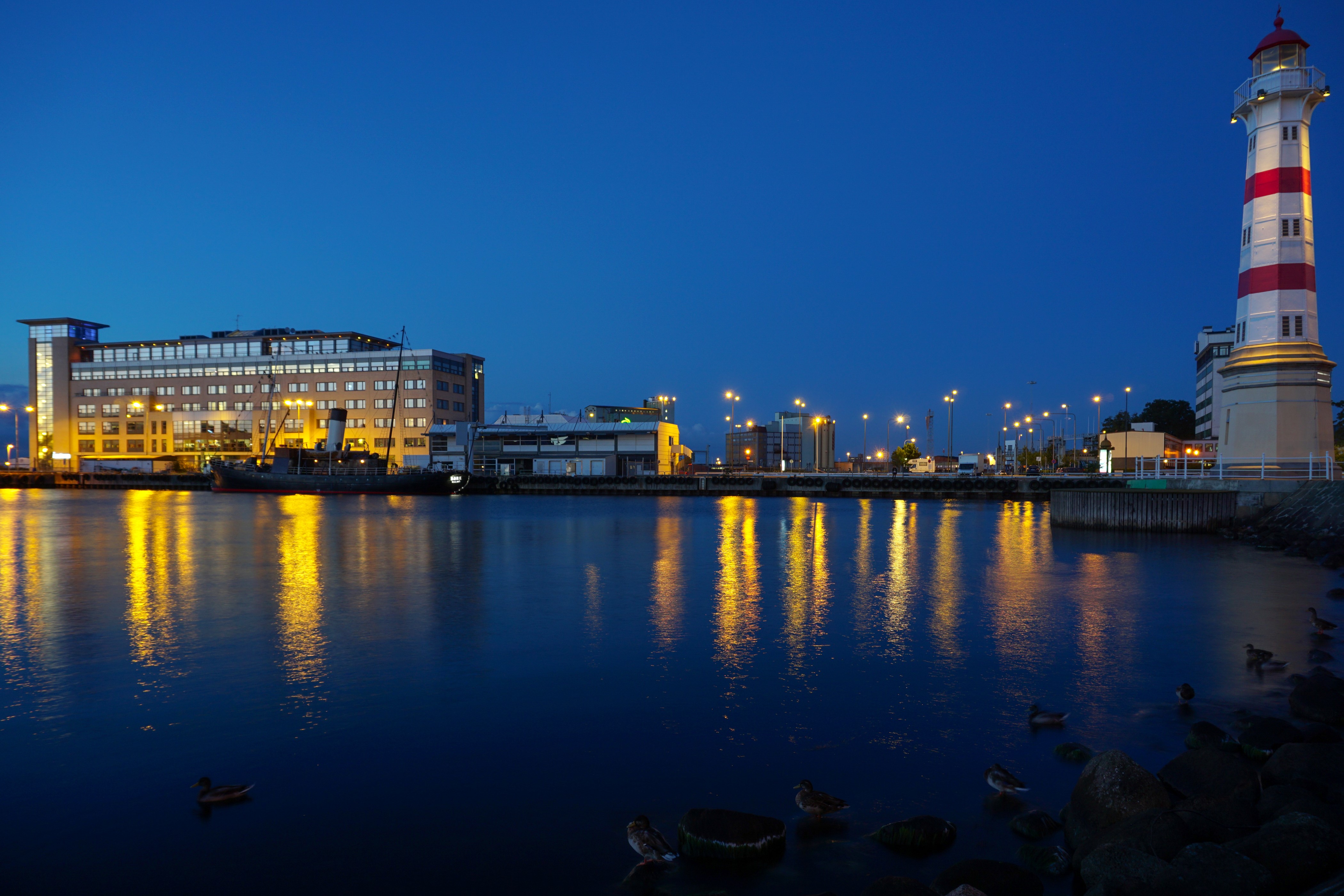 Lighthouse and buildings at night in Sweden HD Wallpaper
