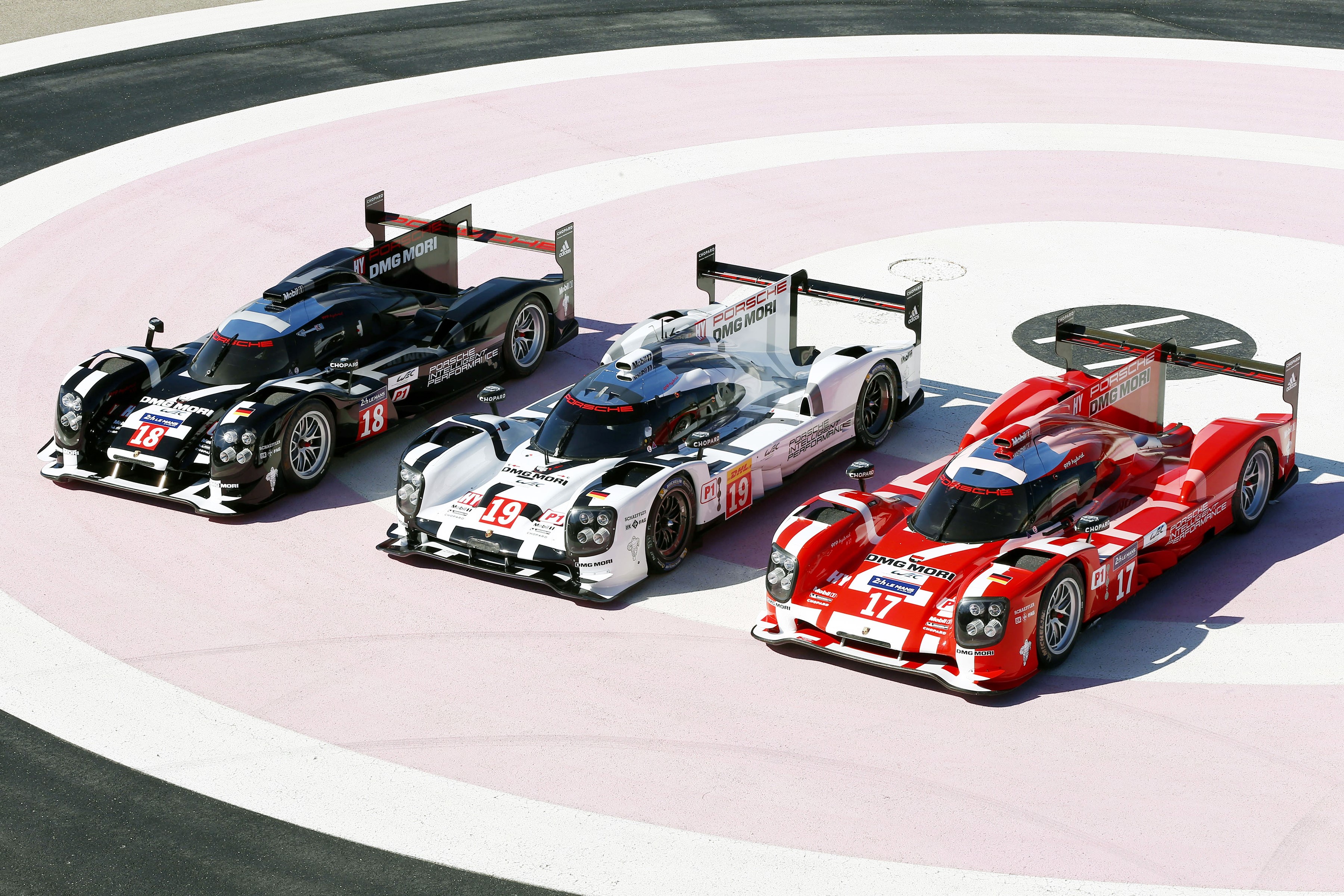 Three Porsche 919 Hybrid race cars on track HD Wallpaper