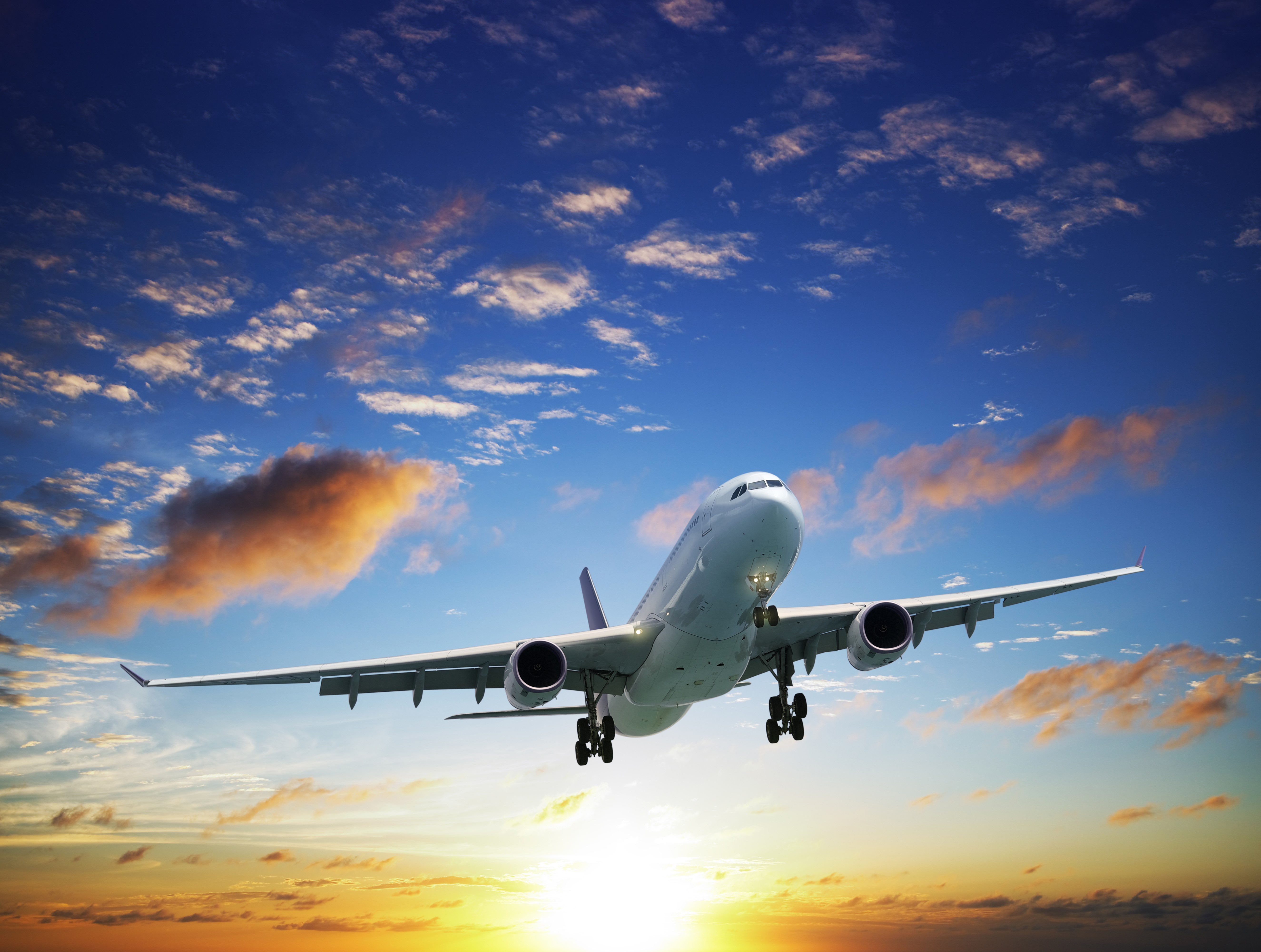 Airplane flying in the sky at sunset HD Wallpaper