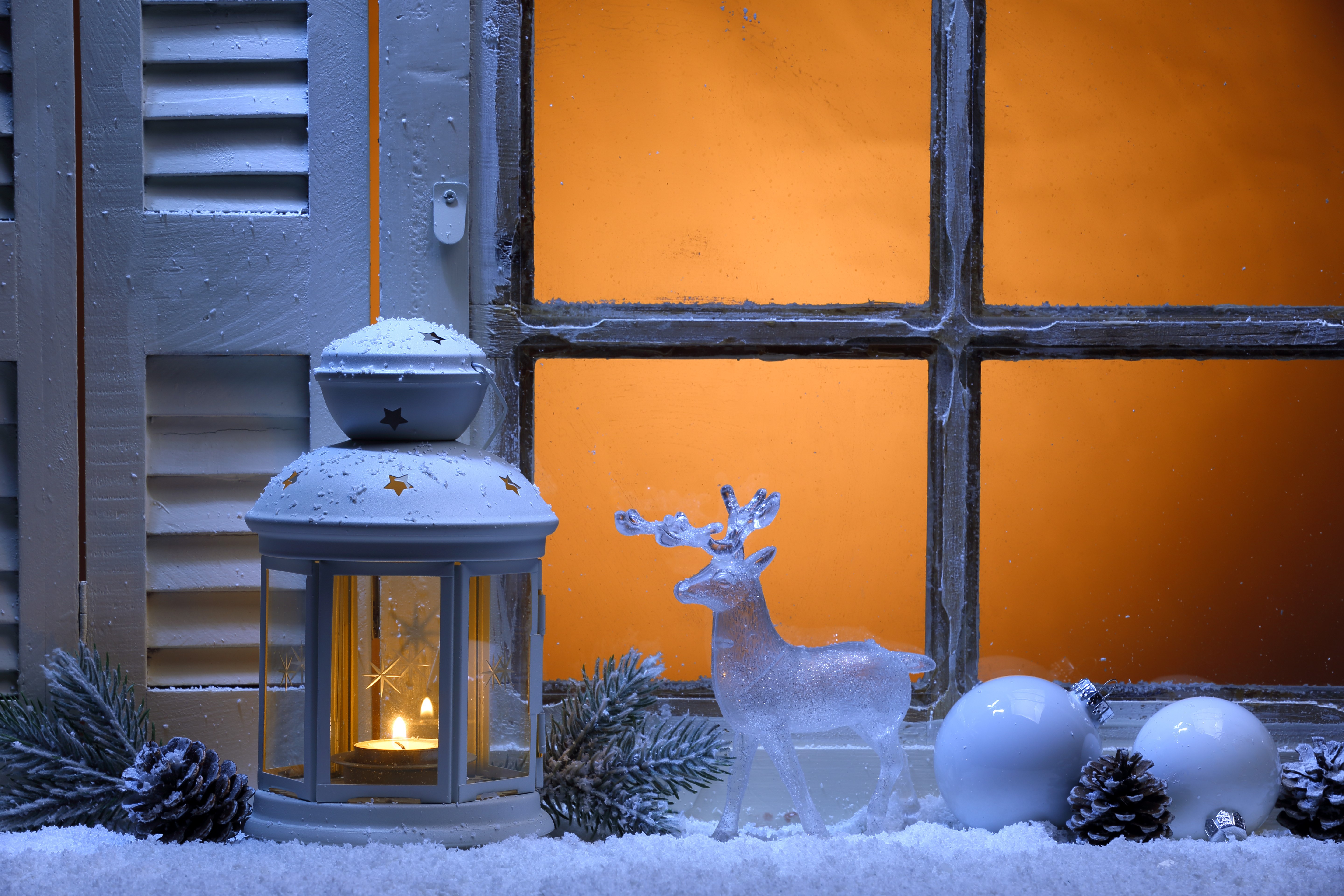 Christmas window decoration with lantern, deer, and ornaments HD Wallpaper