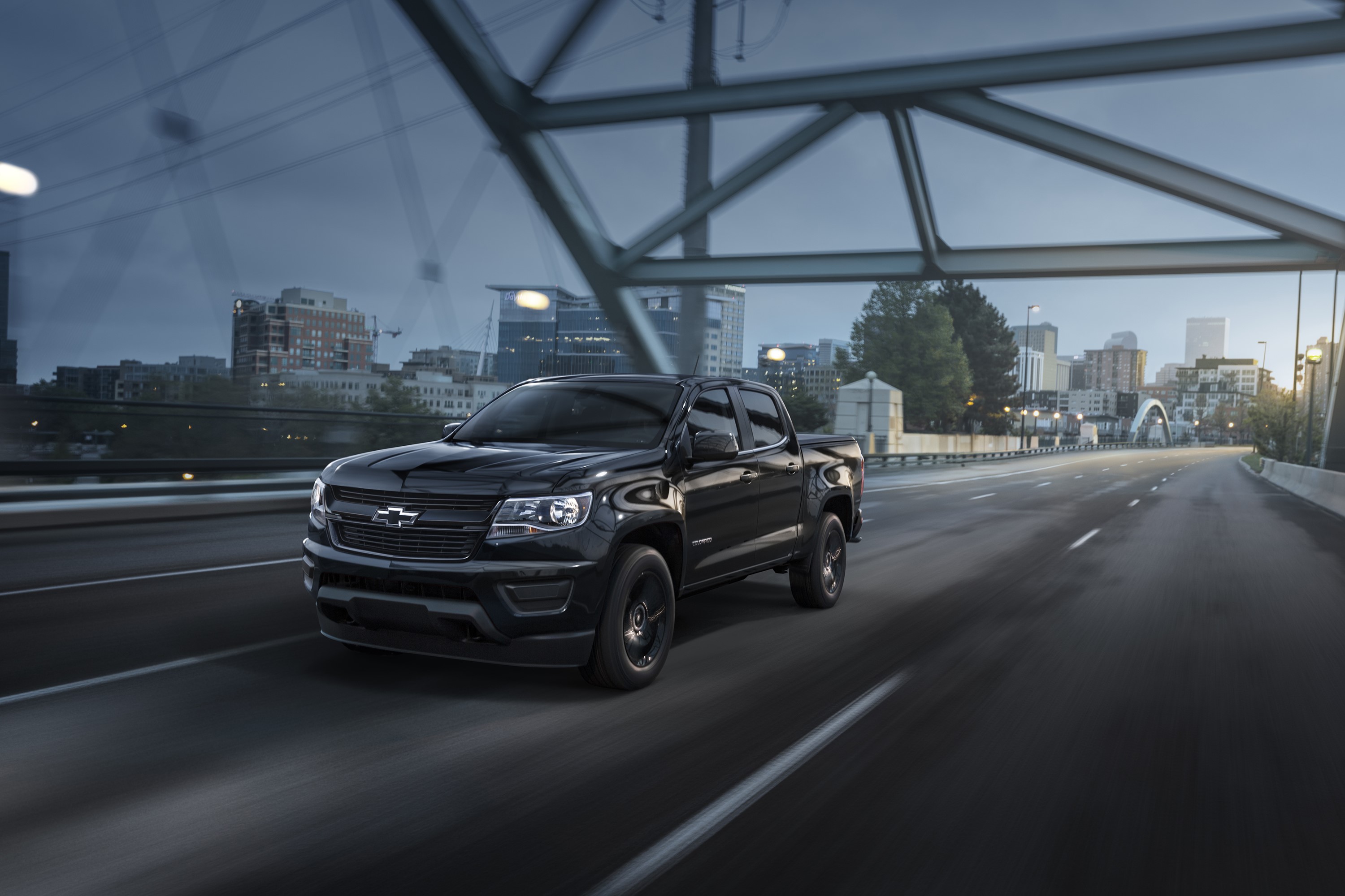 Black Chevrolet Colorado Midnight Crew Cab driving on a bridge HD Wallpaper