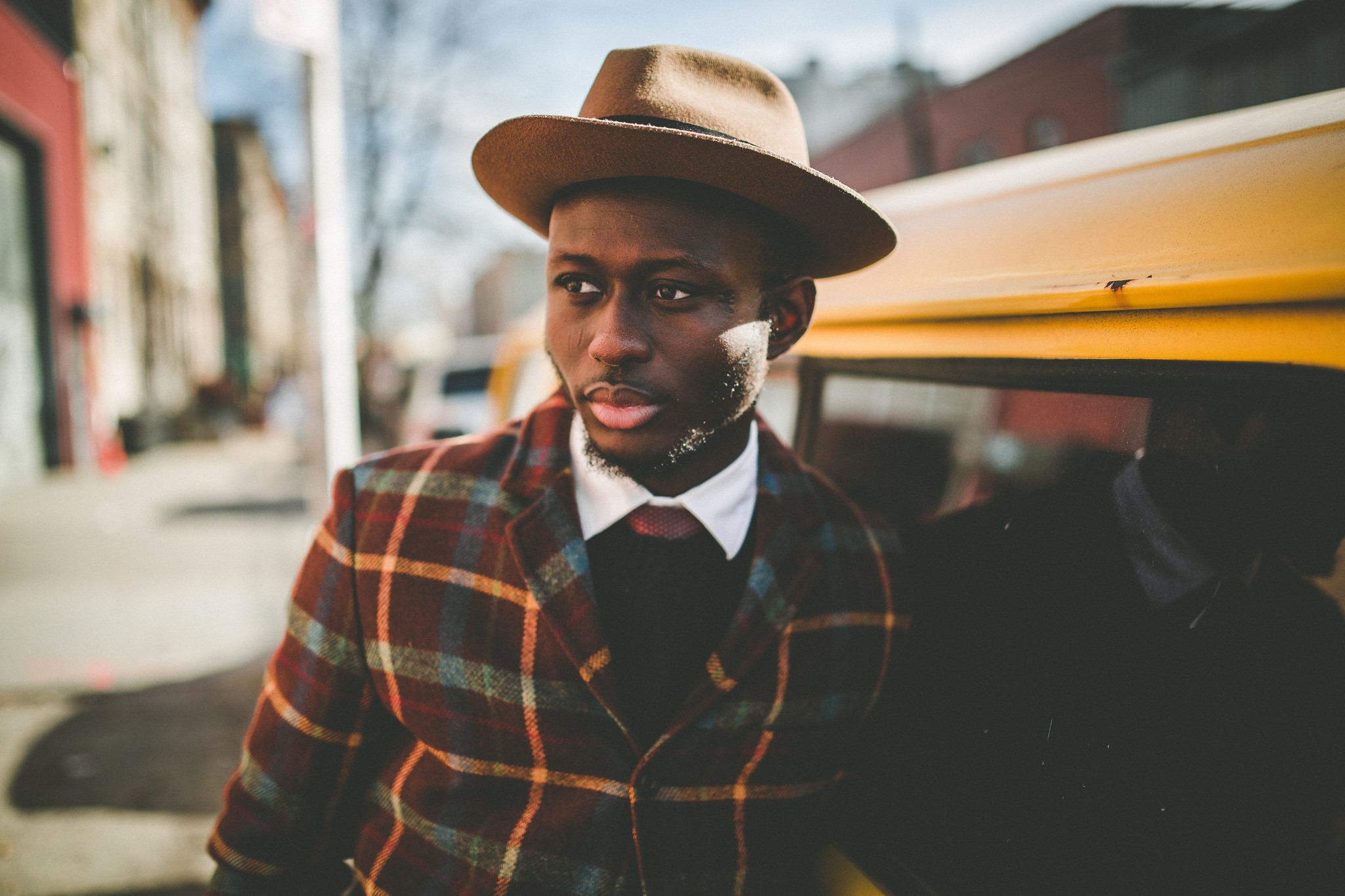 Man in hat and plaid jacket by yellow car HD Wallpaper
