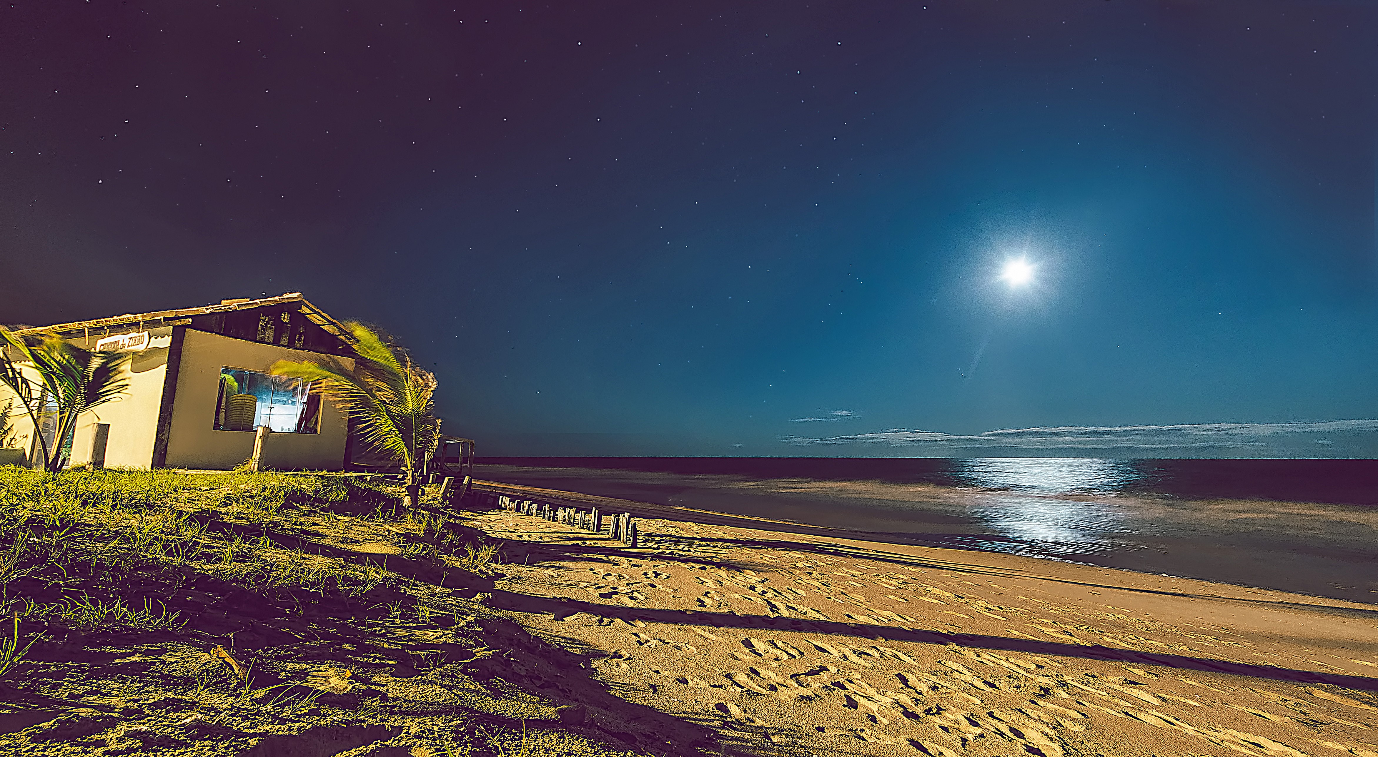 Beach house at night under the moon and stars in Brazil HD Wallpaper