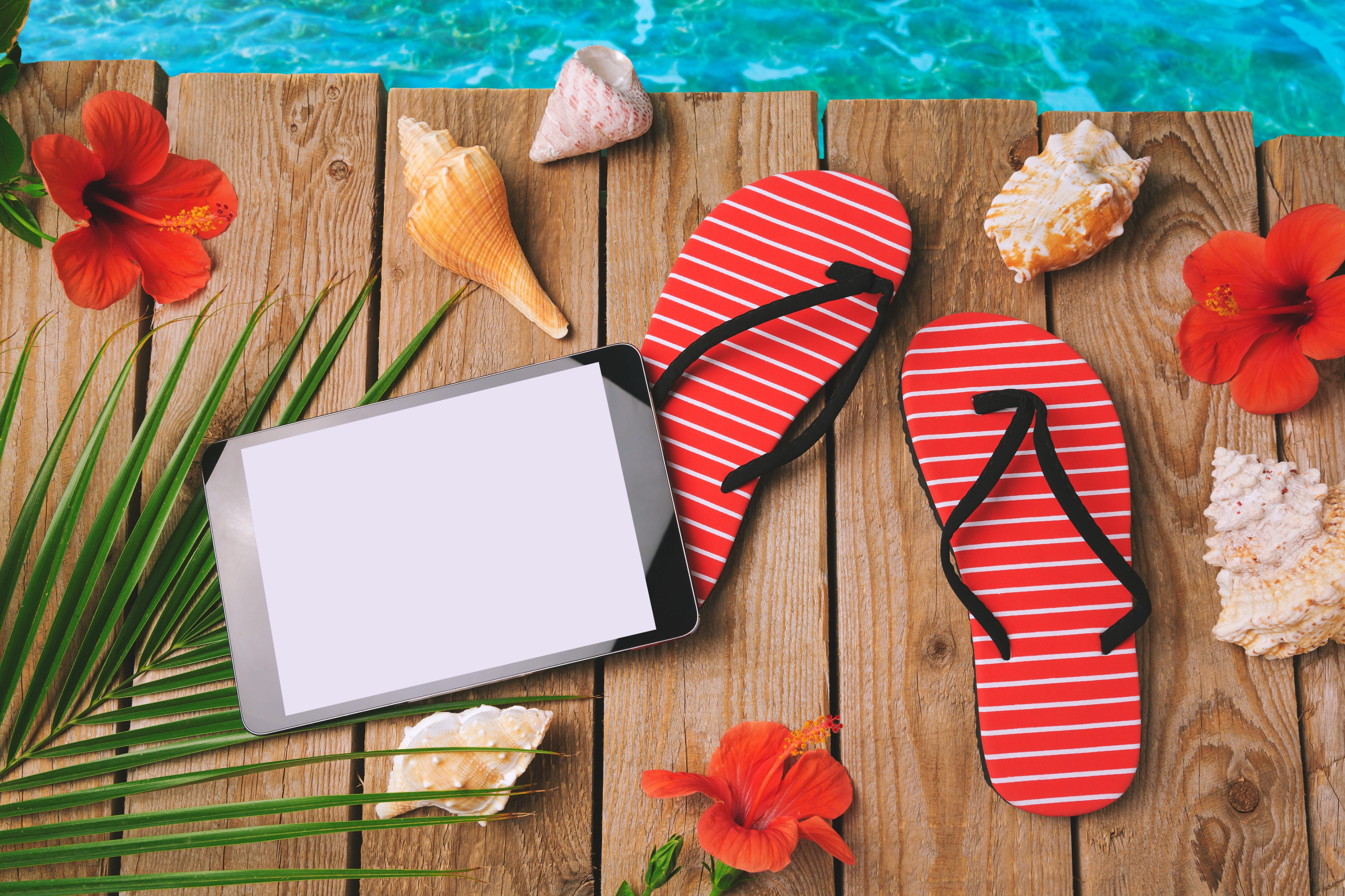 Beach scene with flip-flops, shells, and tablet HD Wallpaper