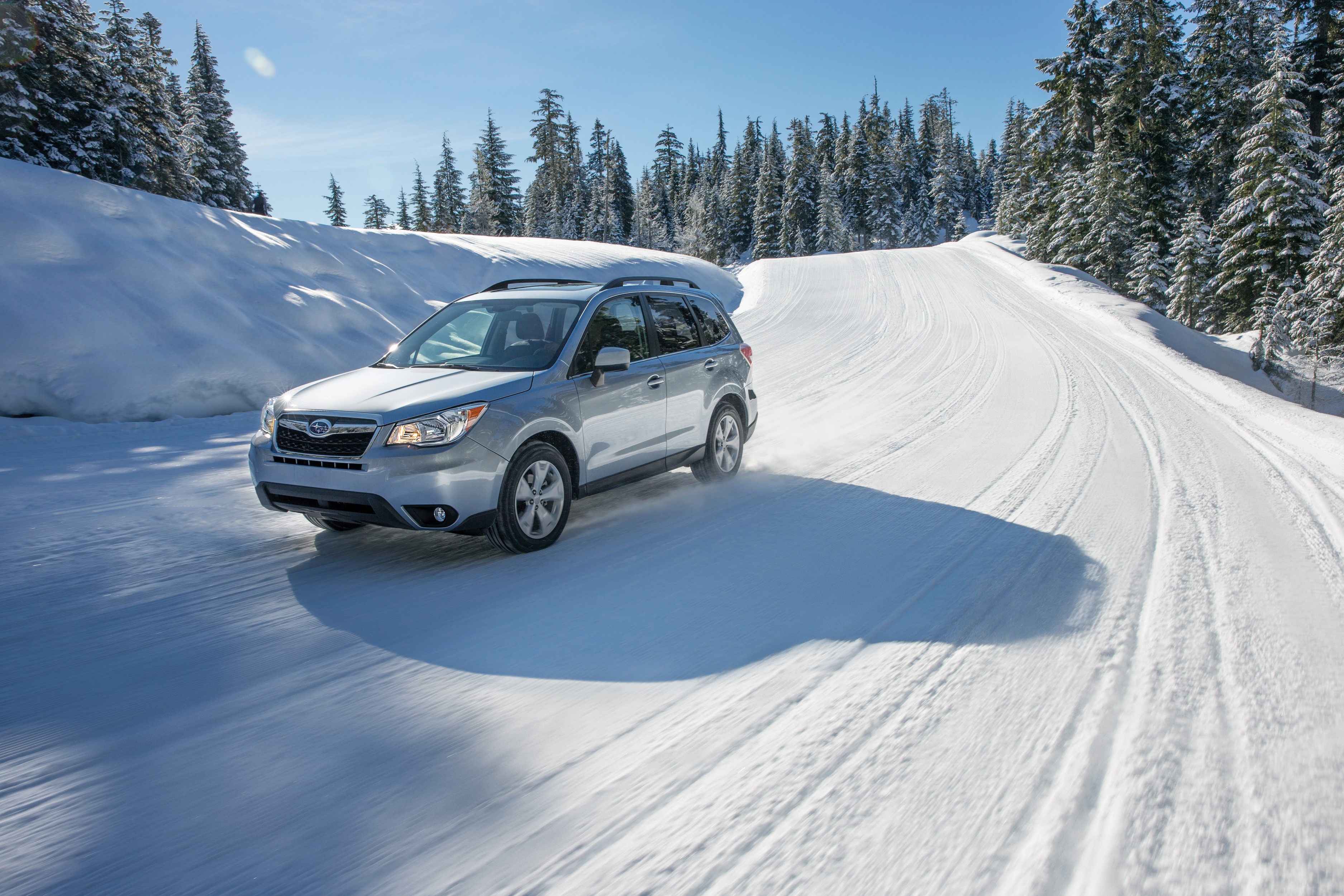 Silver Subaru Forester driving on a snowy road HD Wallpaper