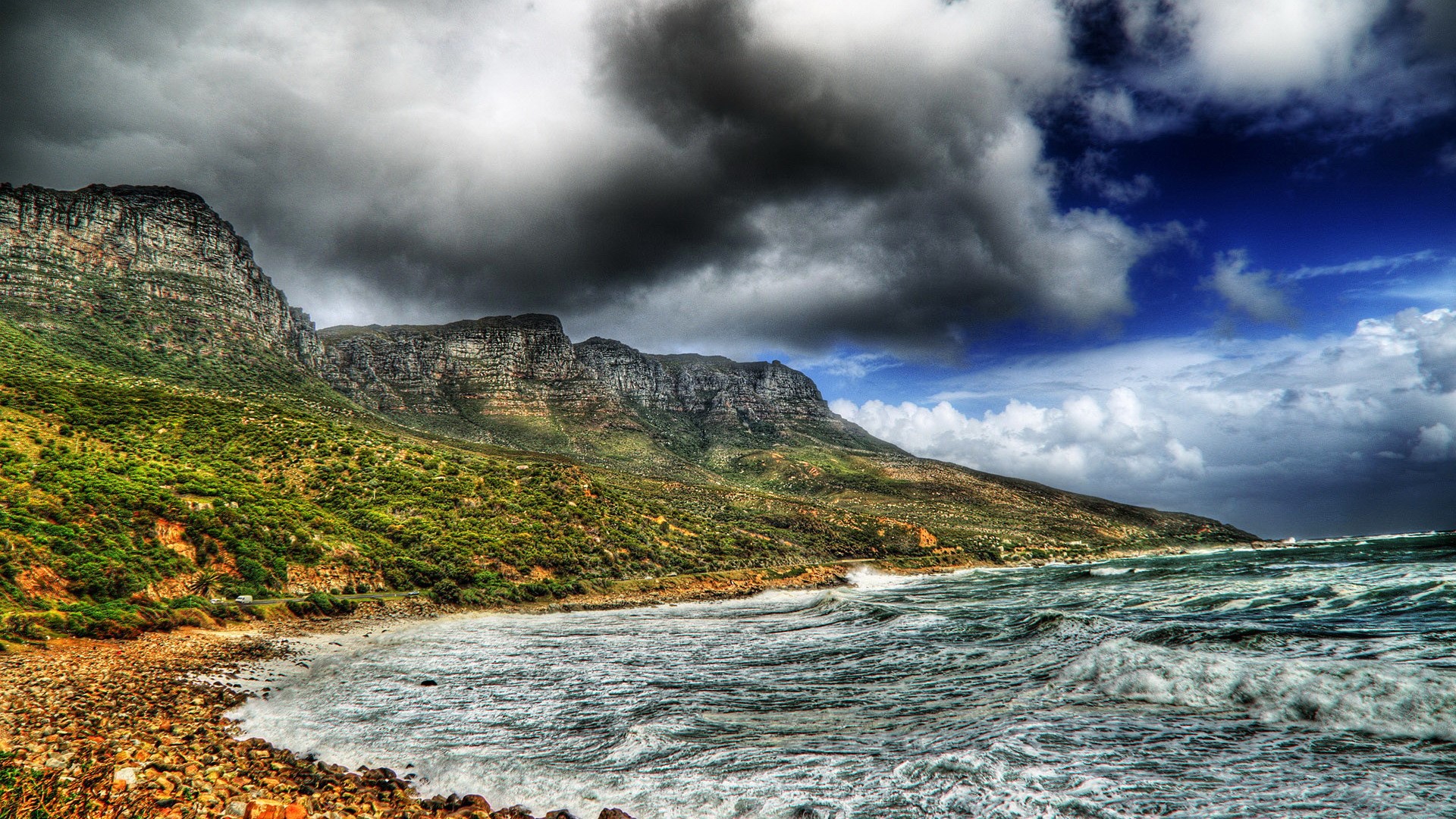 Rocky Coastline with Craggy Mountains and Stormy Clouds HD Wallpaper