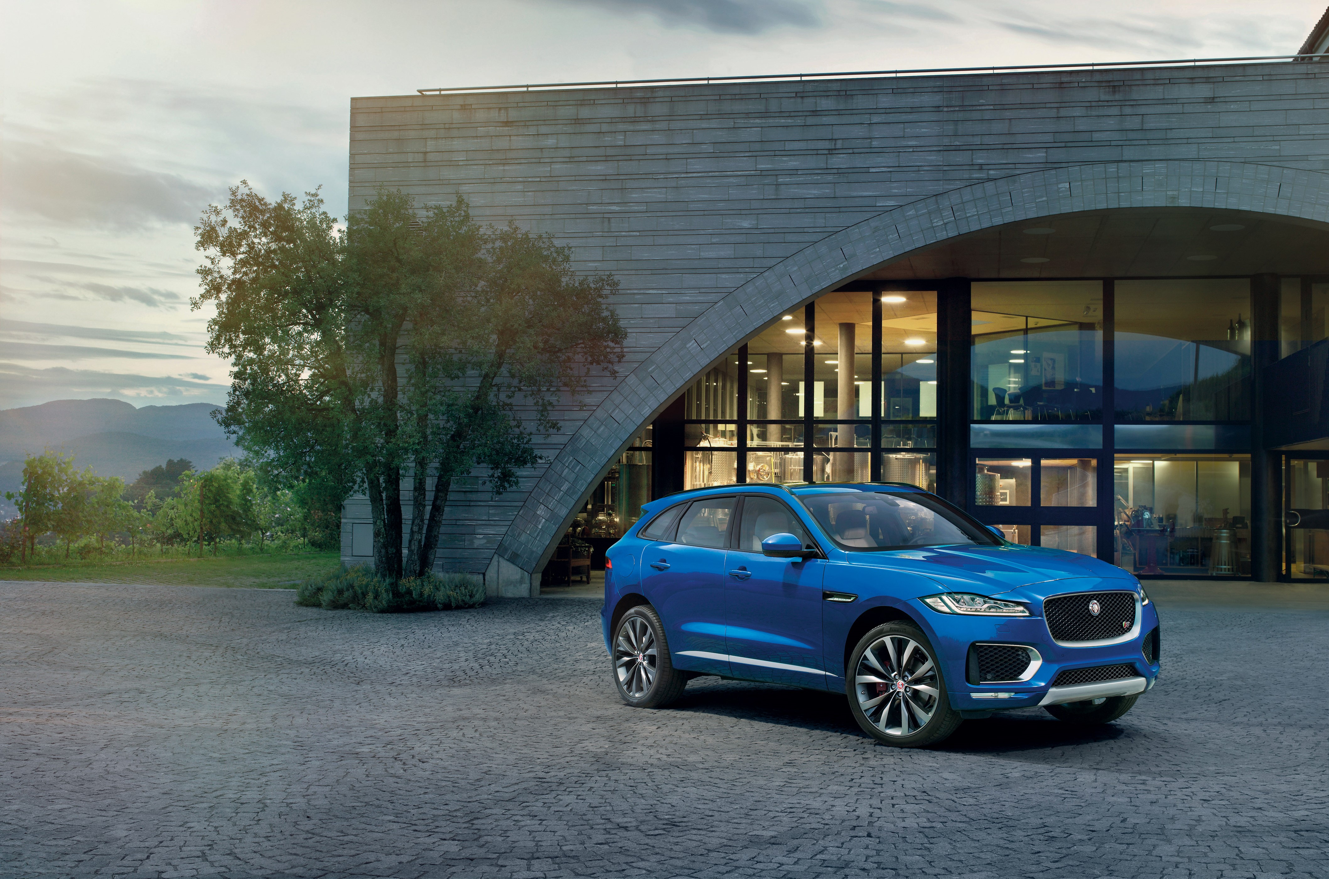 Blue 2015 Jaguar F-Pace LE S parked outside building HD Wallpaper