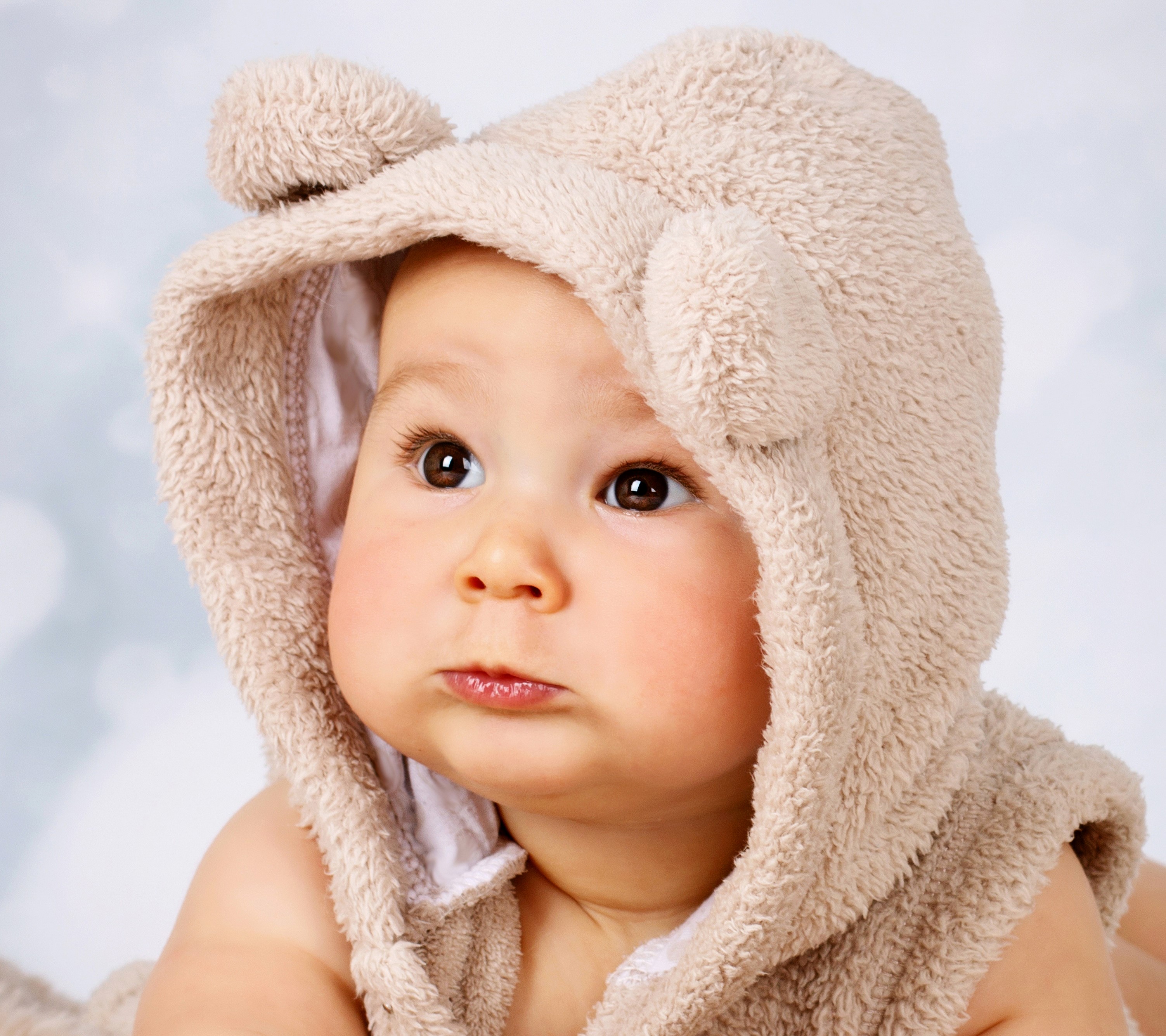 Baby wearing a fuzzy bear hat HD Wallpaper