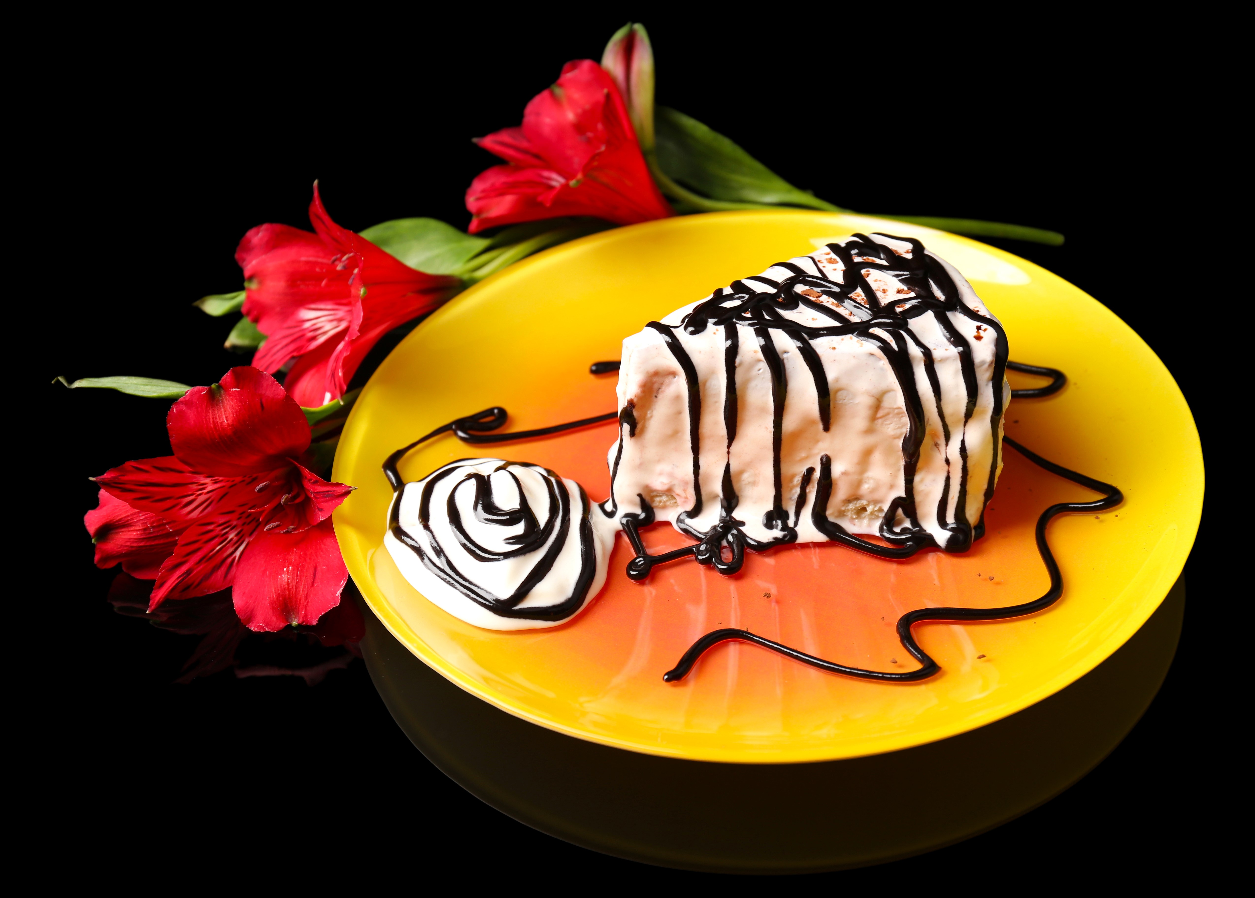 Slice of cake with chocolate drizzle and alstroemeria flowers HD Wallpaper