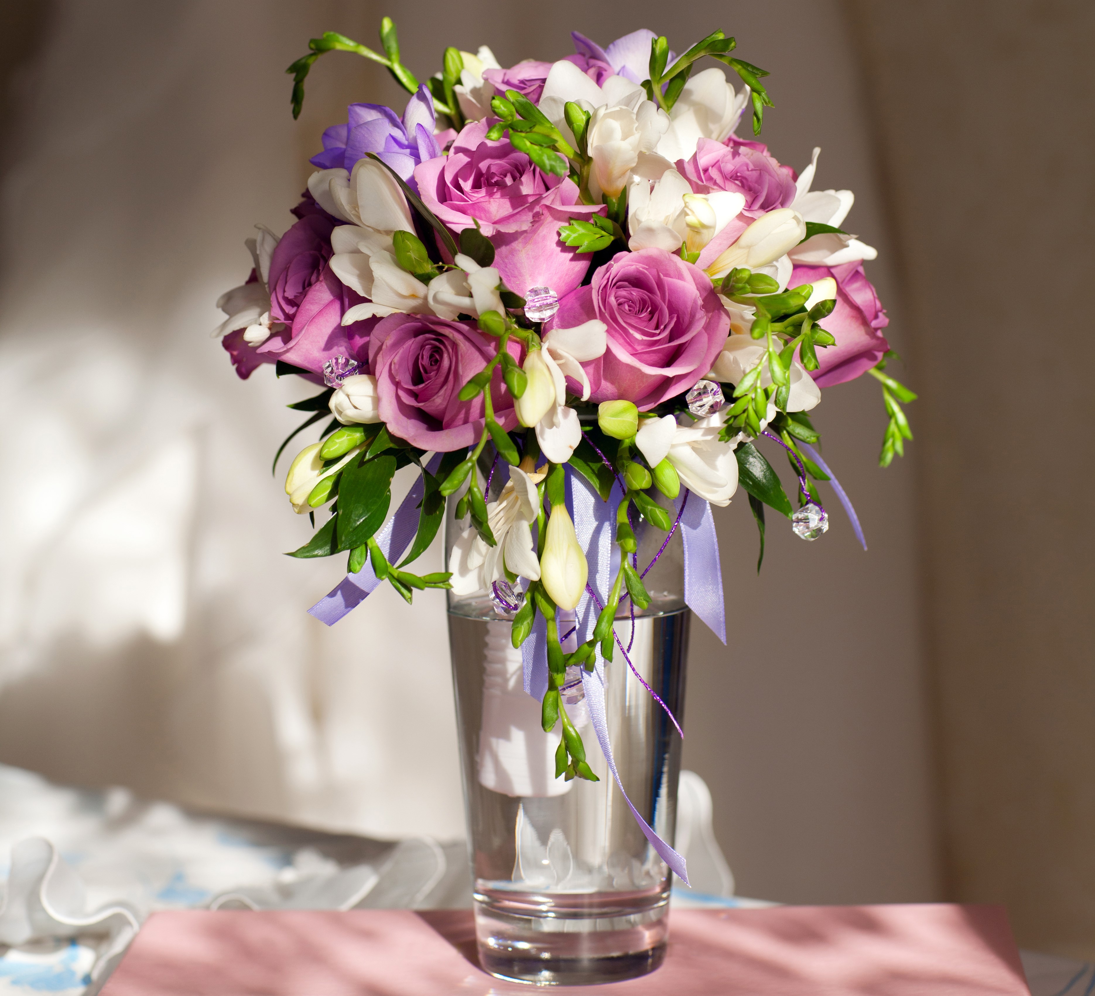 Purple roses and white freesia bouquet in a glass vase HD Wallpaper