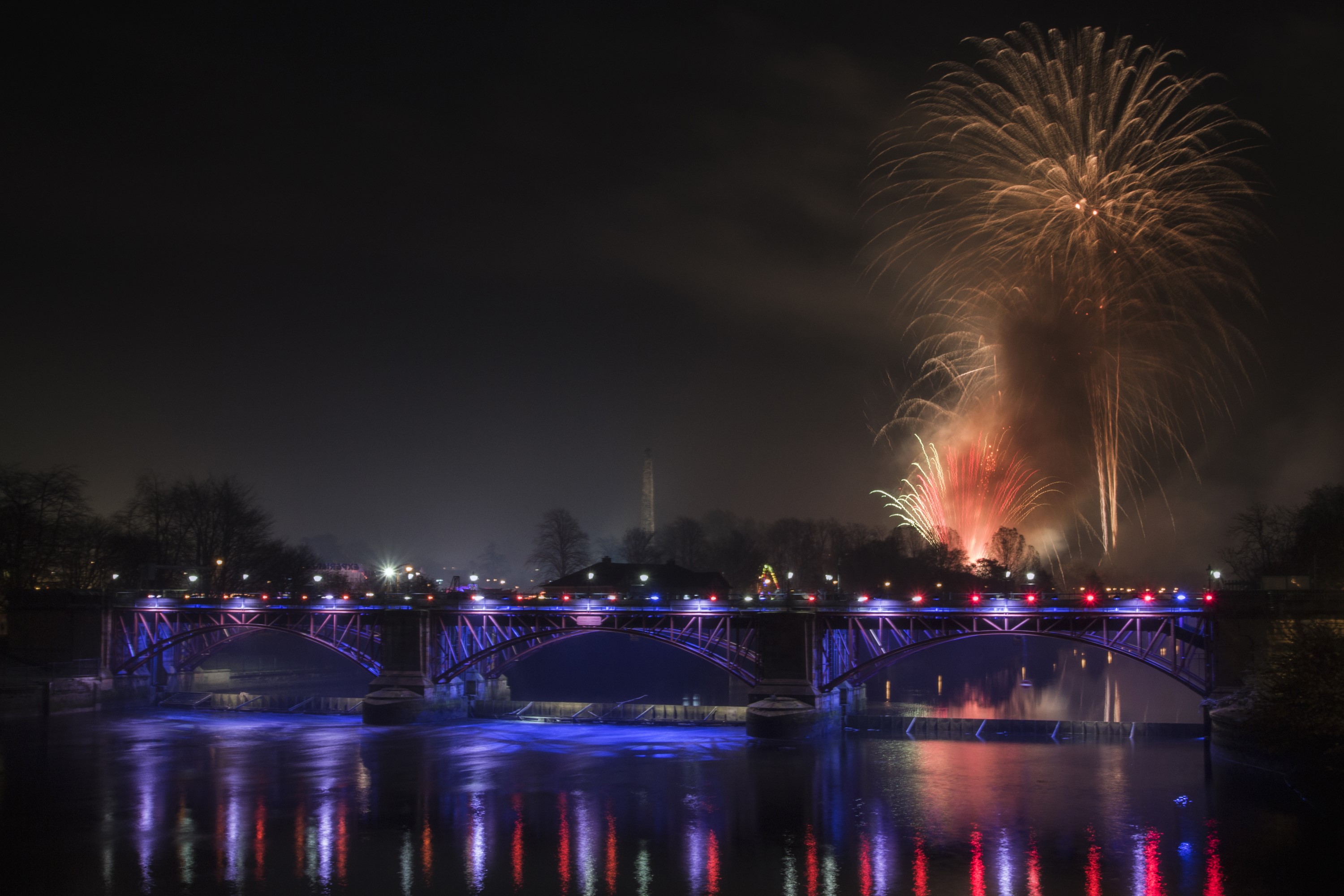 Fireworks over a bridge at night HD Wallpaper