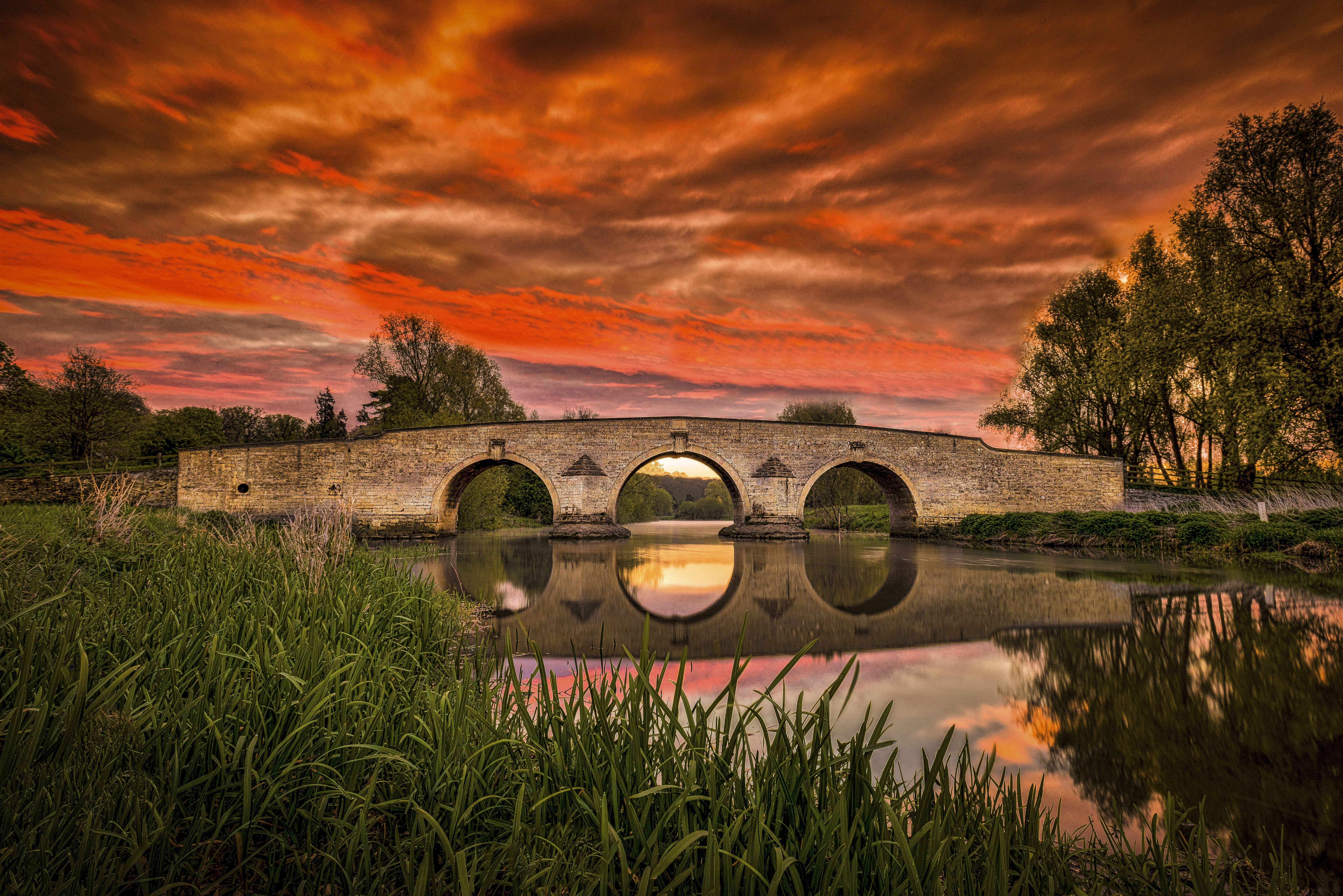Stone bridge over river at sunset HD Wallpaper