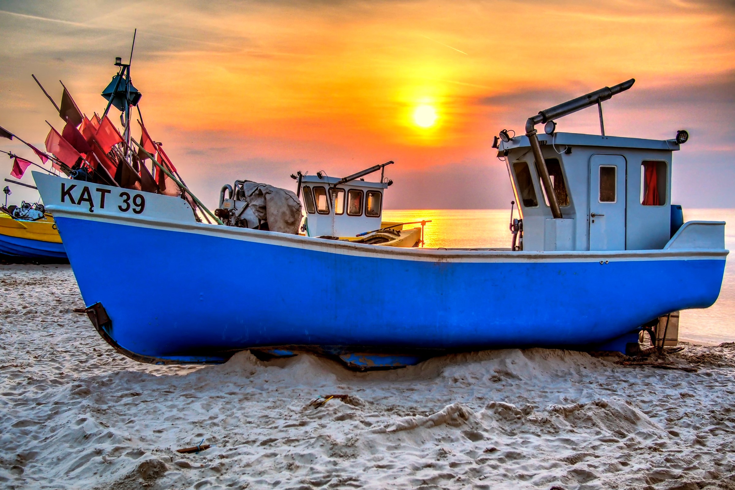 Fishing boats on a beach at sunset HD Wallpaper