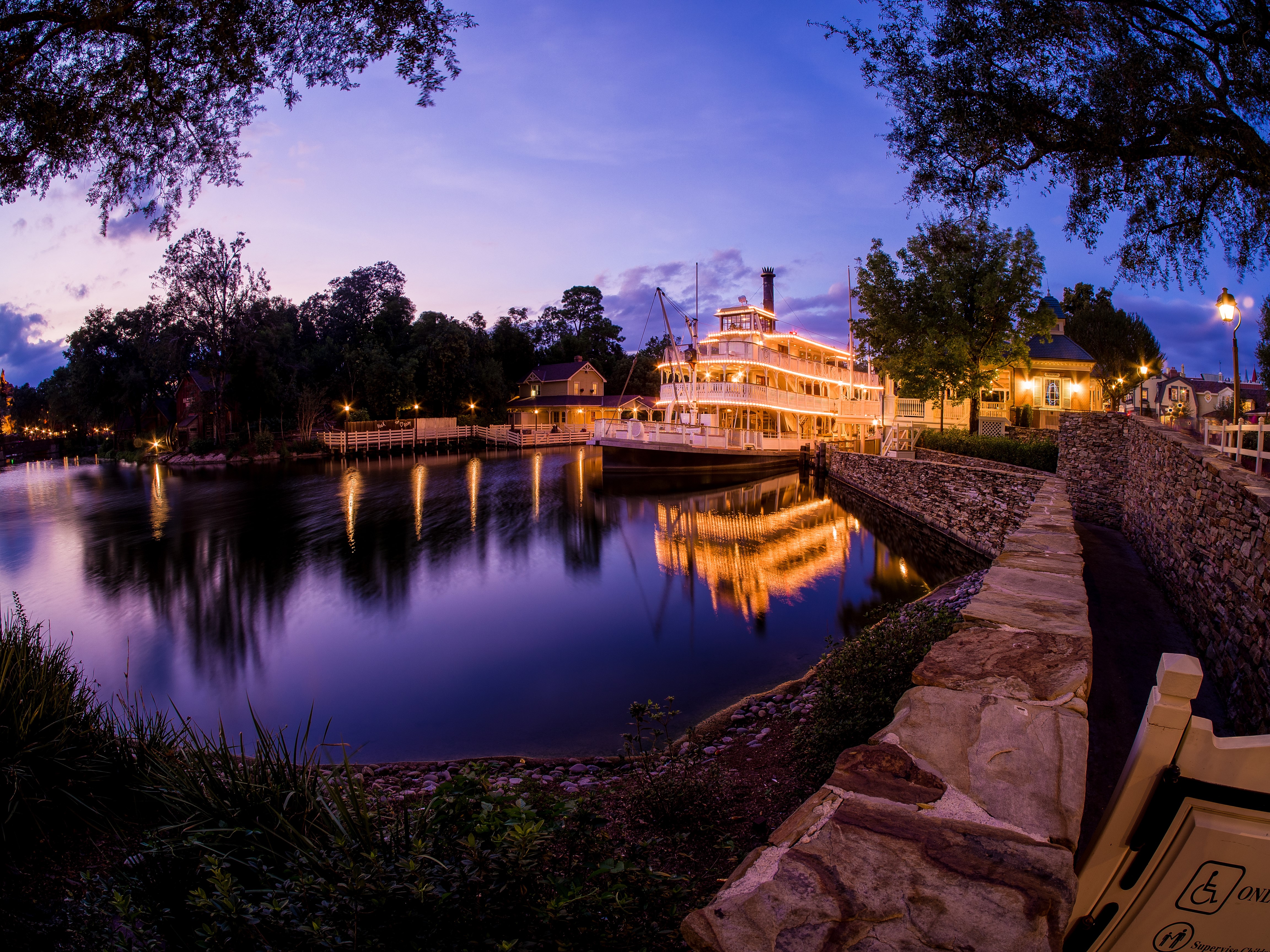 Steamboat on a river at dusk in Disneyland HD Wallpaper