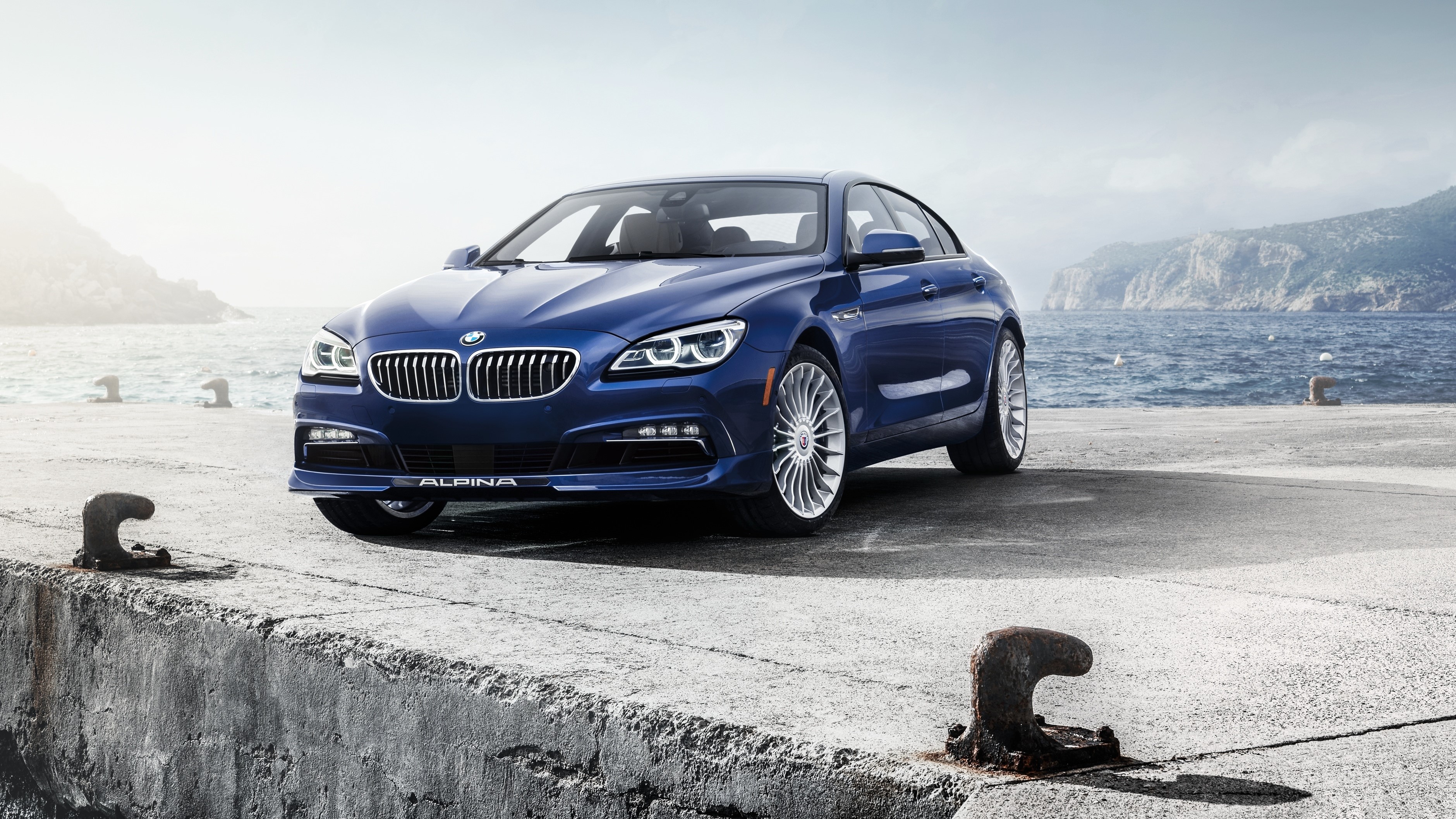 Blue 2015 Alpina B6 xDrive Gran Coupe parked on a dock HD Wallpaper