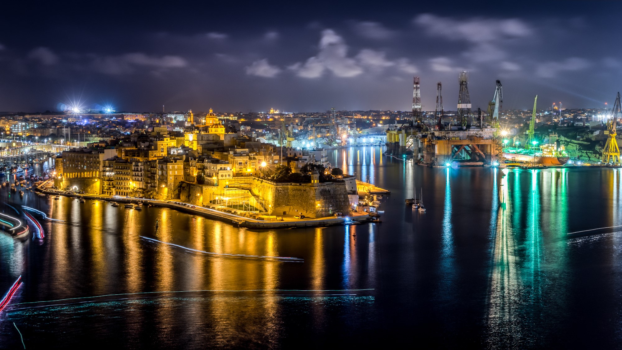 Valletta, Malta waterfront at night with harbor cranes HD Wallpaper