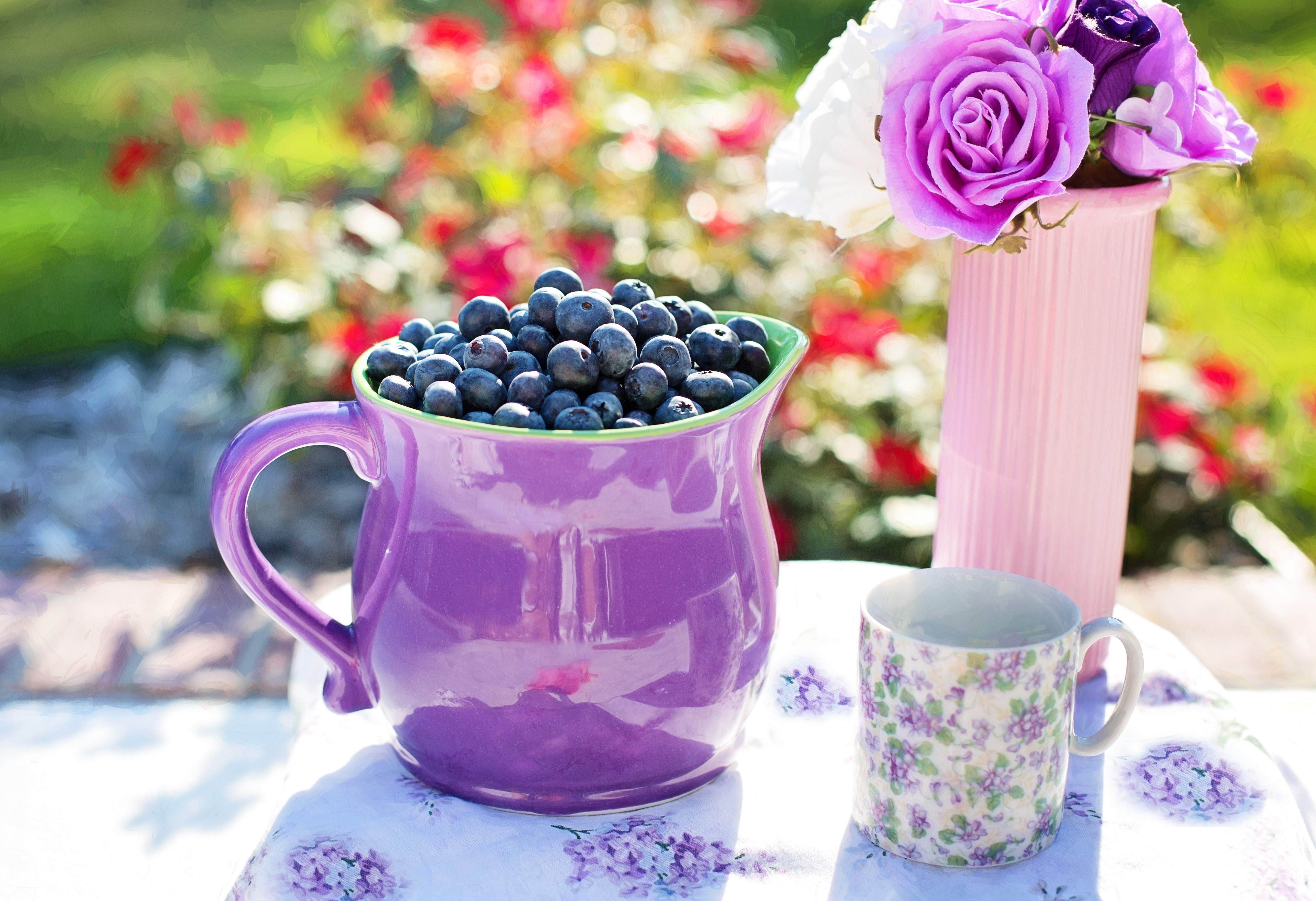 Blueberries in a purple jug with flowers HD Wallpaper