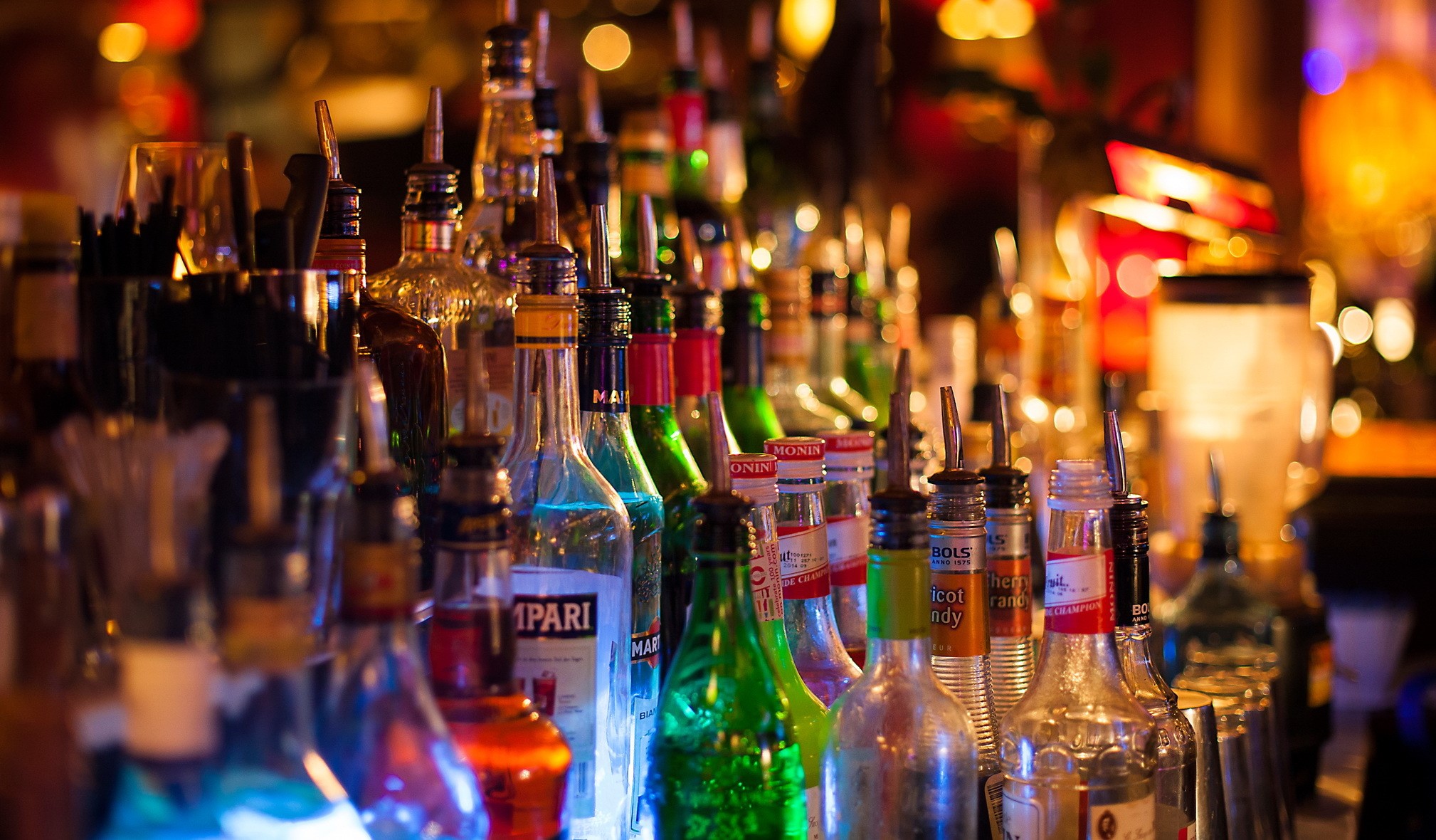 Bottles of alcohol on a bar counter HD Wallpaper