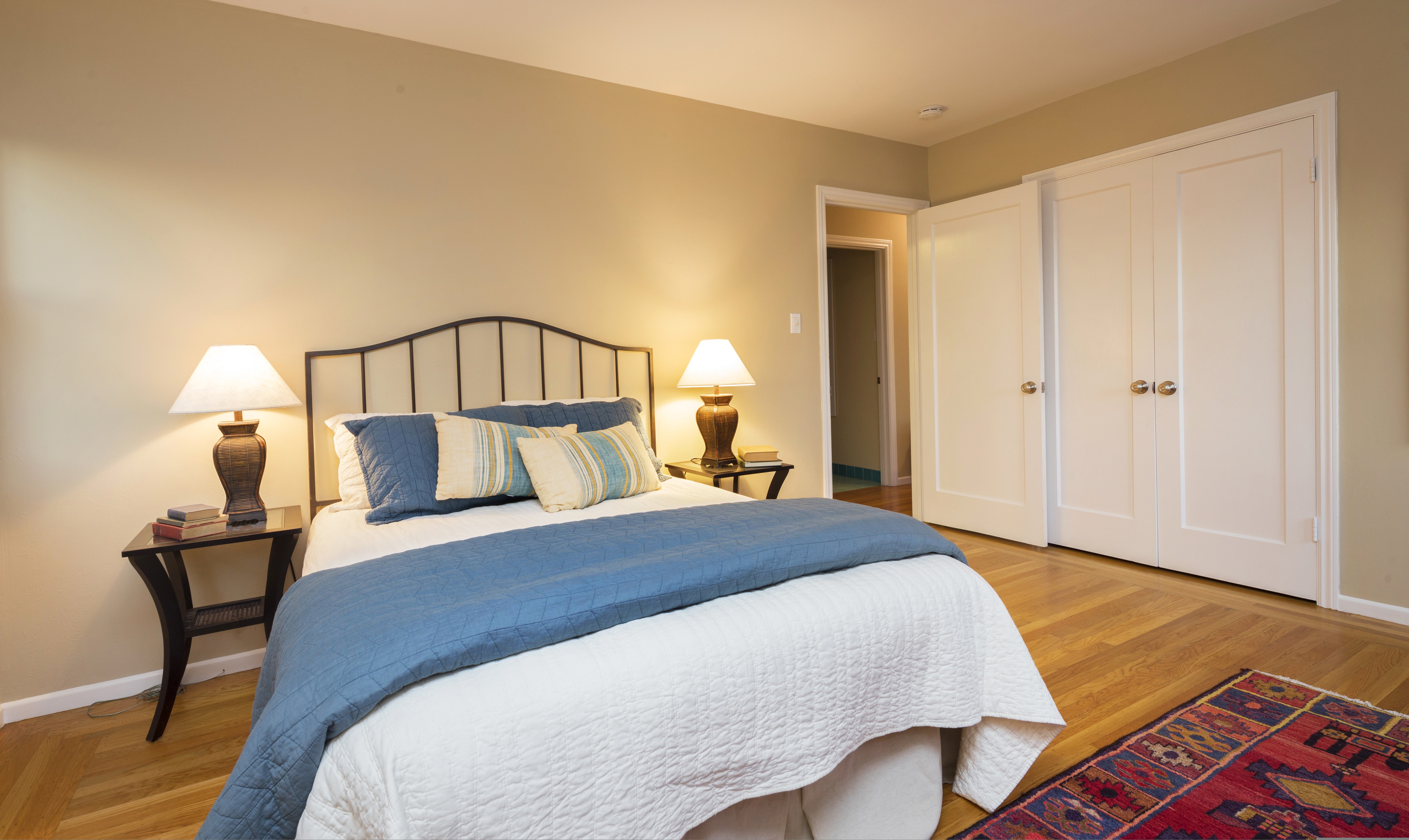 Bedroom with bed, lamps, and closet HD Wallpaper