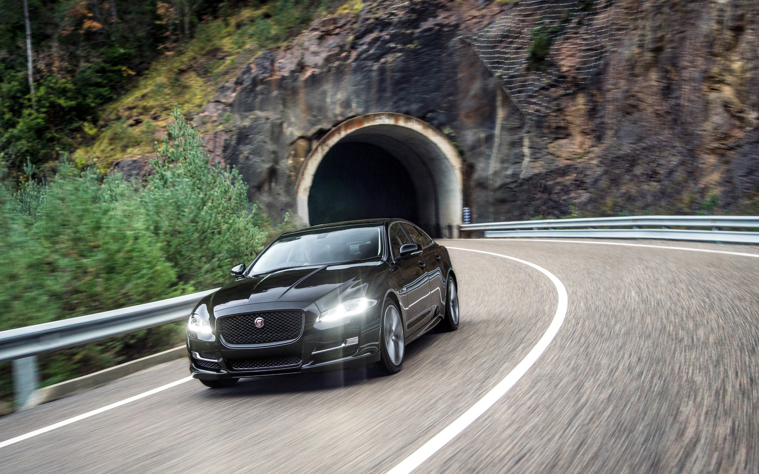 Black 2015 Jaguar XJ R-Sport driving near tunnel HD Wallpaper