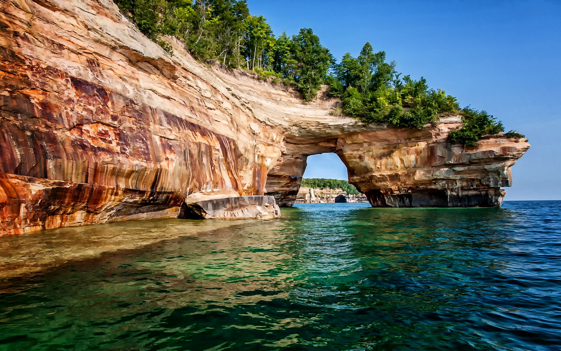 Arch rock formation on a lake HD Wallpaper