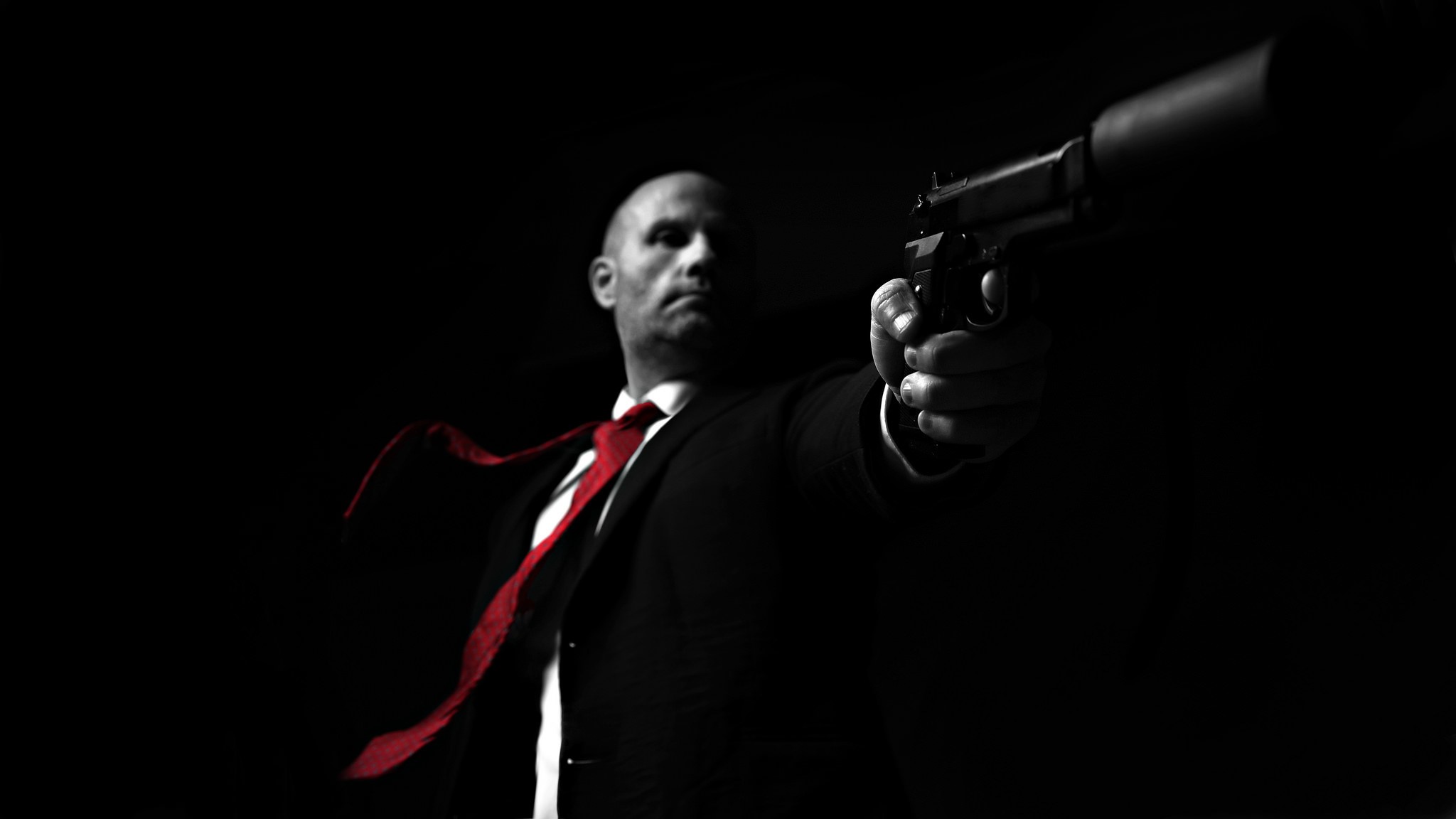 Man in Suit with Red Tie Holding Pistol HD Wallpaper
