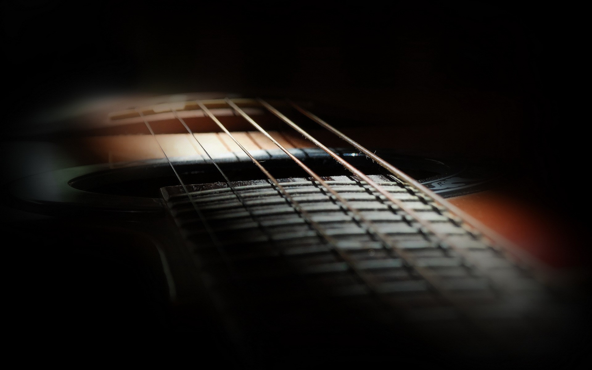 Closeup of acoustic guitar strings and fretboard HD Wallpaper