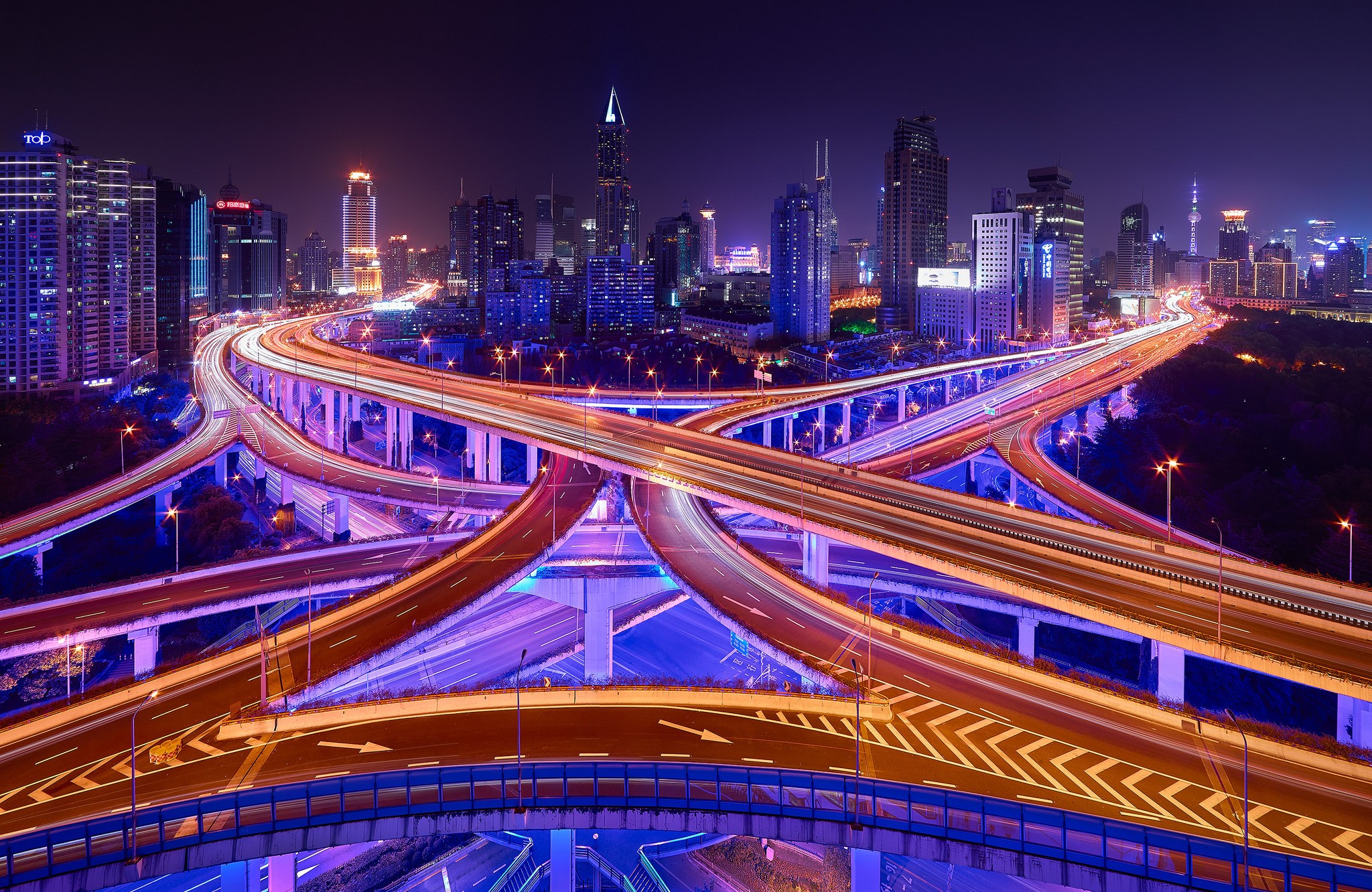 City highway interchange at night with light trails HD Wallpaper