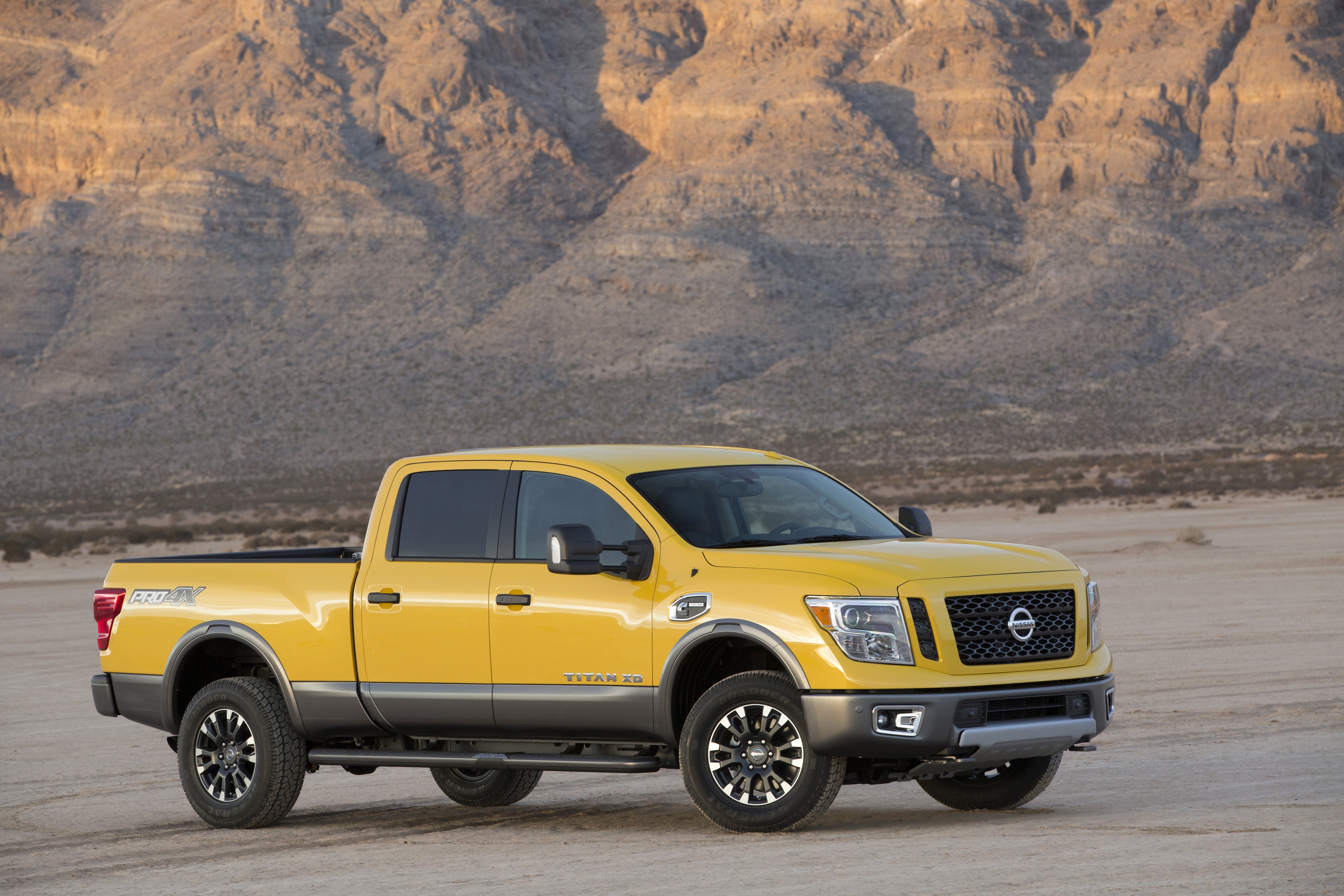 Yellow 2016 Nissan Titan XD in desert HD Wallpaper