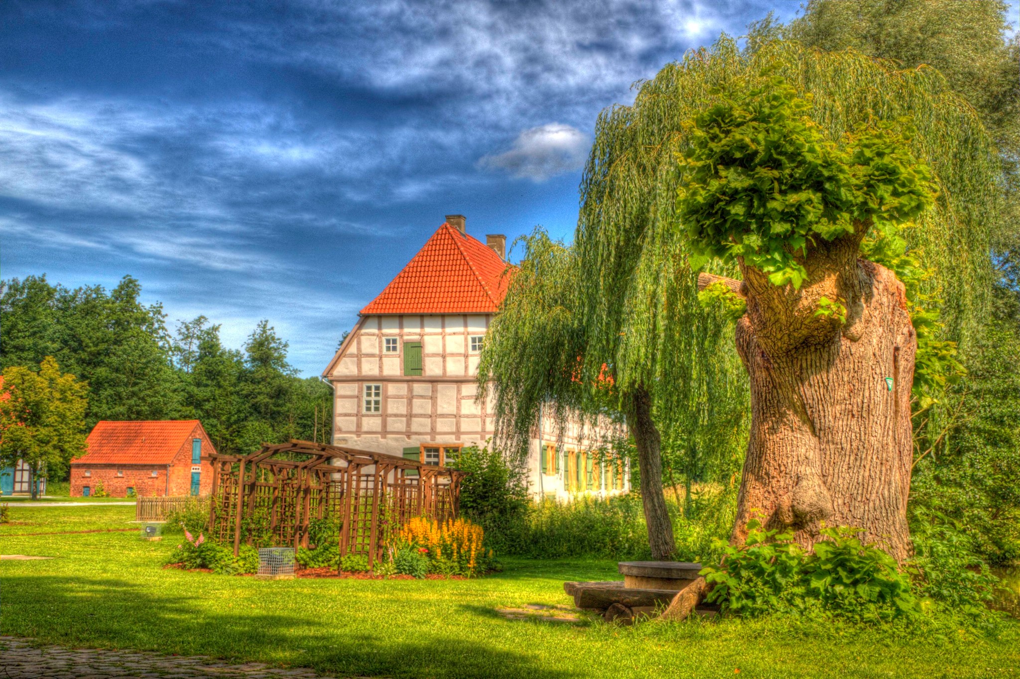 Half-timbered house and outbuilding with trees HD Wallpaper
