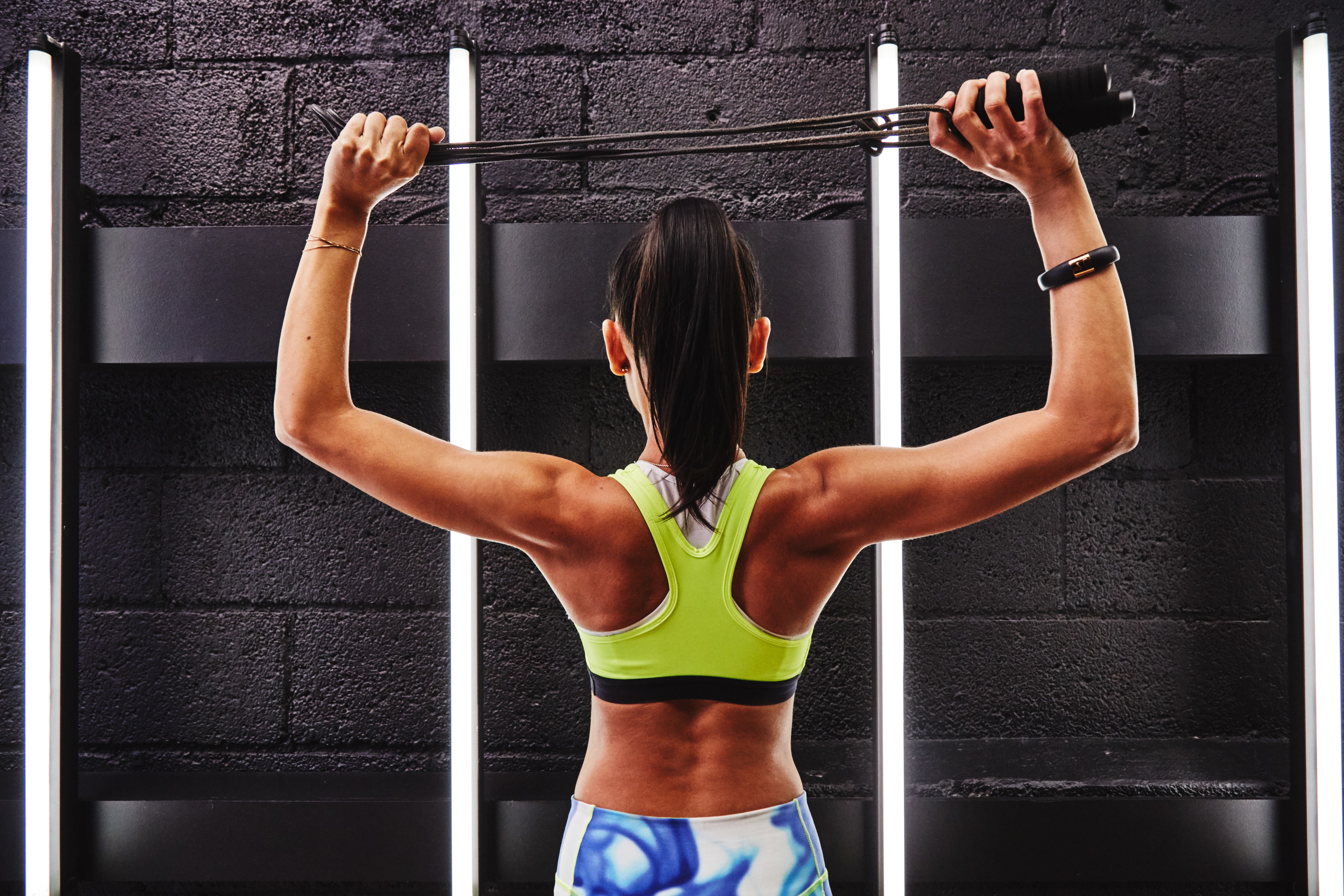Woman exercising with resistance bands HD Wallpaper