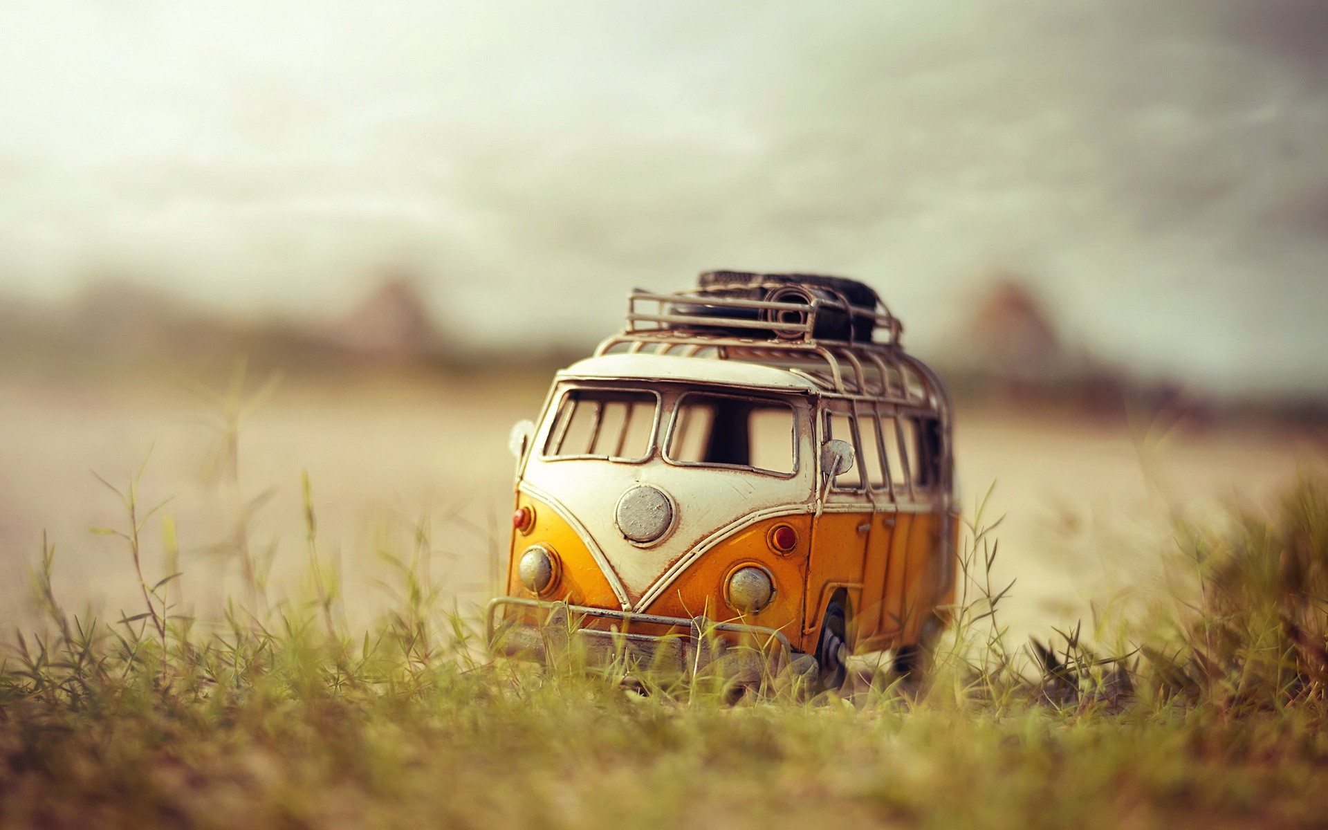 Yellow and white Volkswagen toy van in grass HD Wallpaper