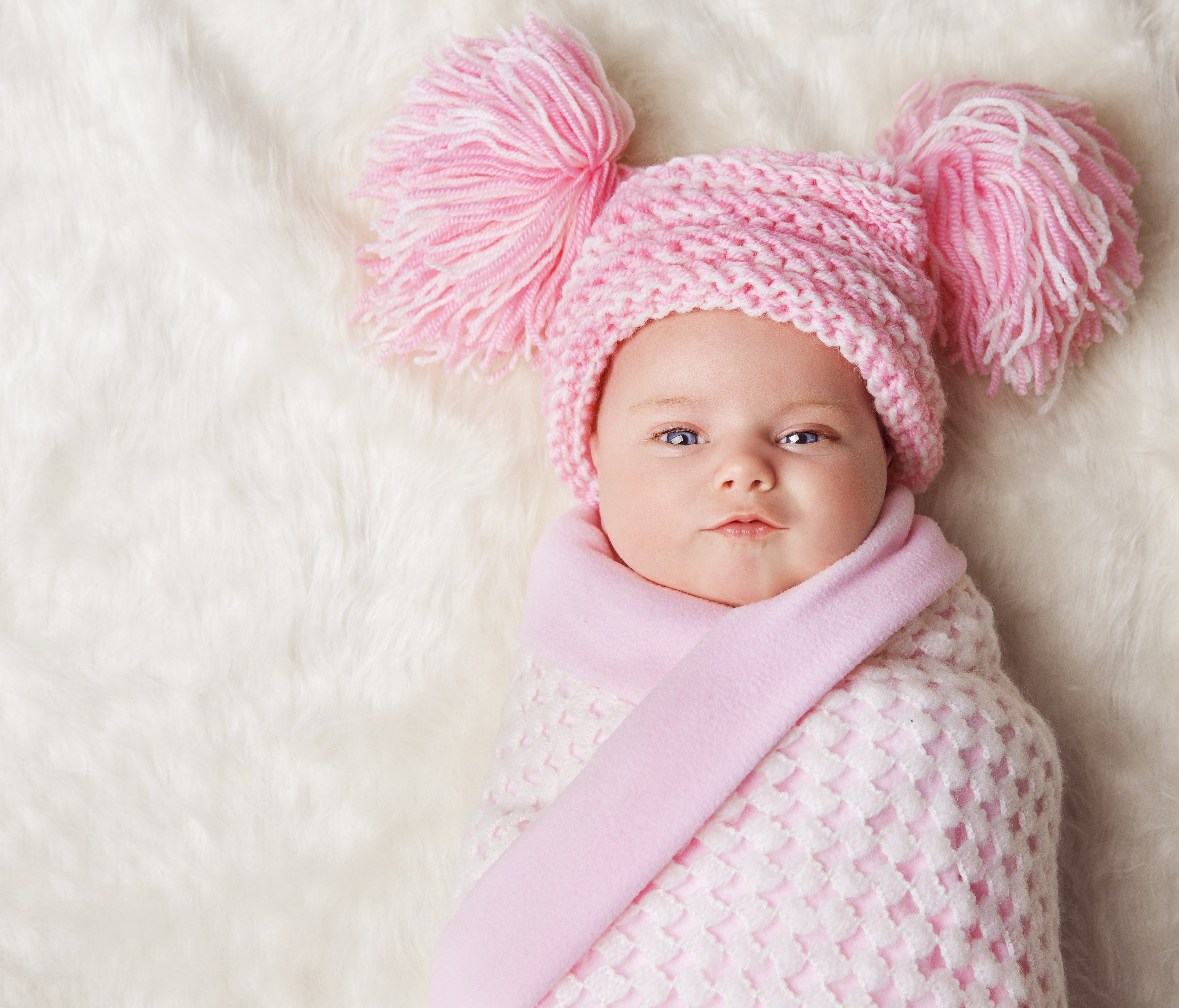 Baby wearing a pink winter hat and blanket HD Wallpaper