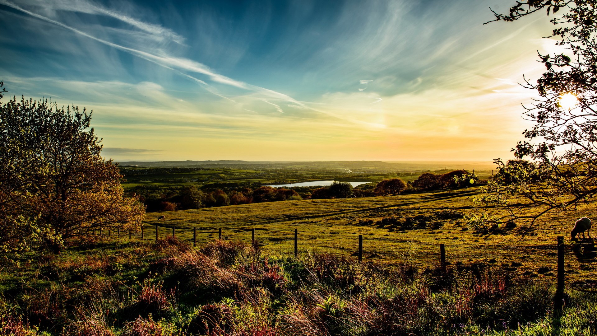 Sunset over rolling hills with a lake HD Wallpaper