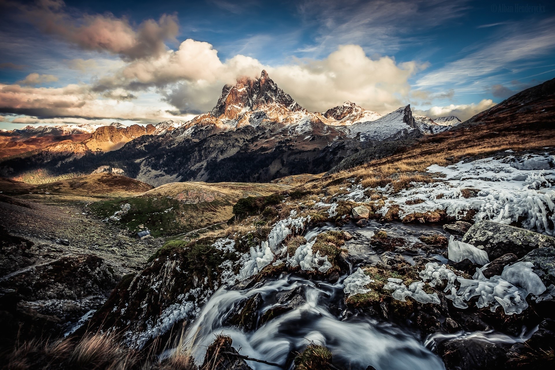 Mountain peak with ice and stream in clouds HD Wallpaper