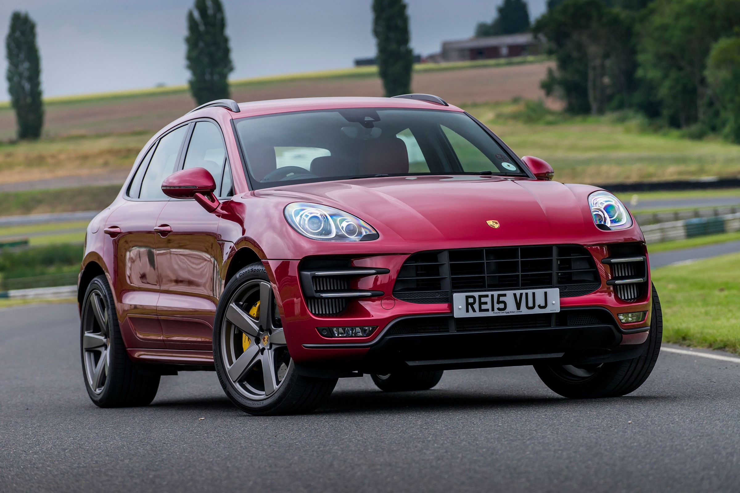 Red Porsche Macan Turbo on a Racetrack HD Wallpaper