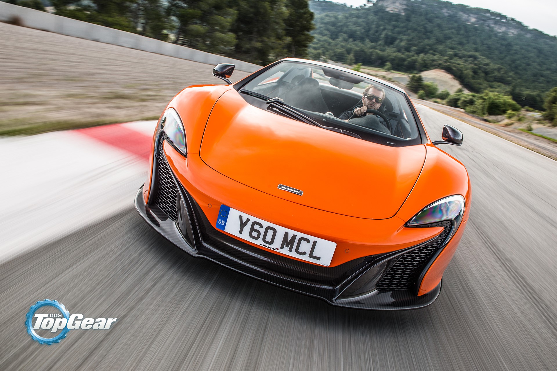 Orange McLaren 650S Spider driving on a track HD Wallpaper
