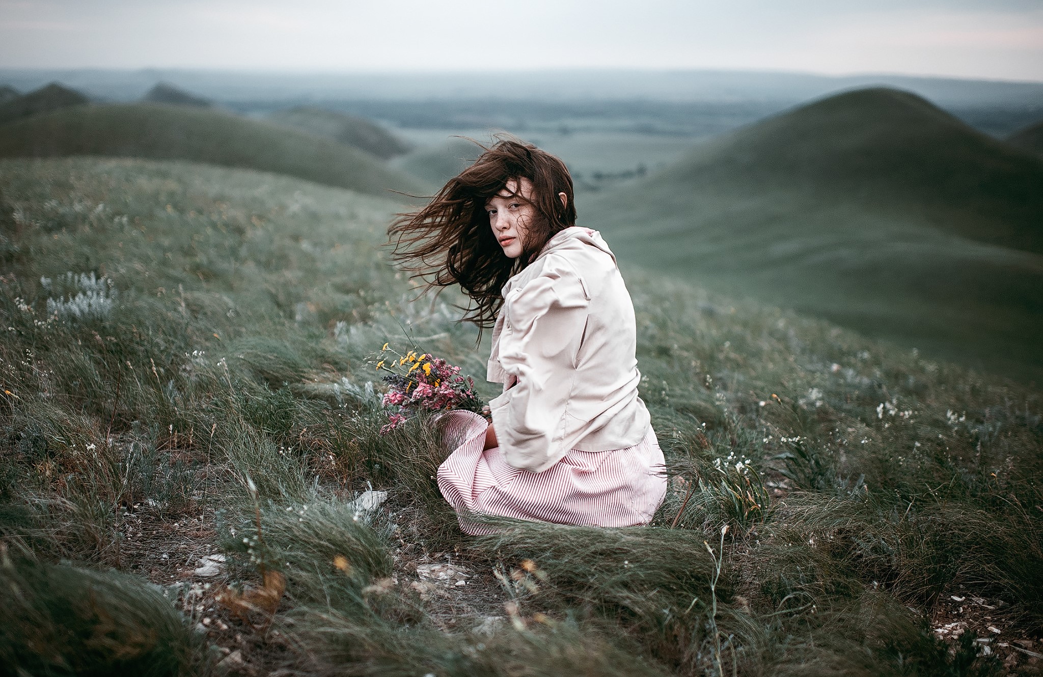 Girl with flowers on a grassy hill HD Wallpaper