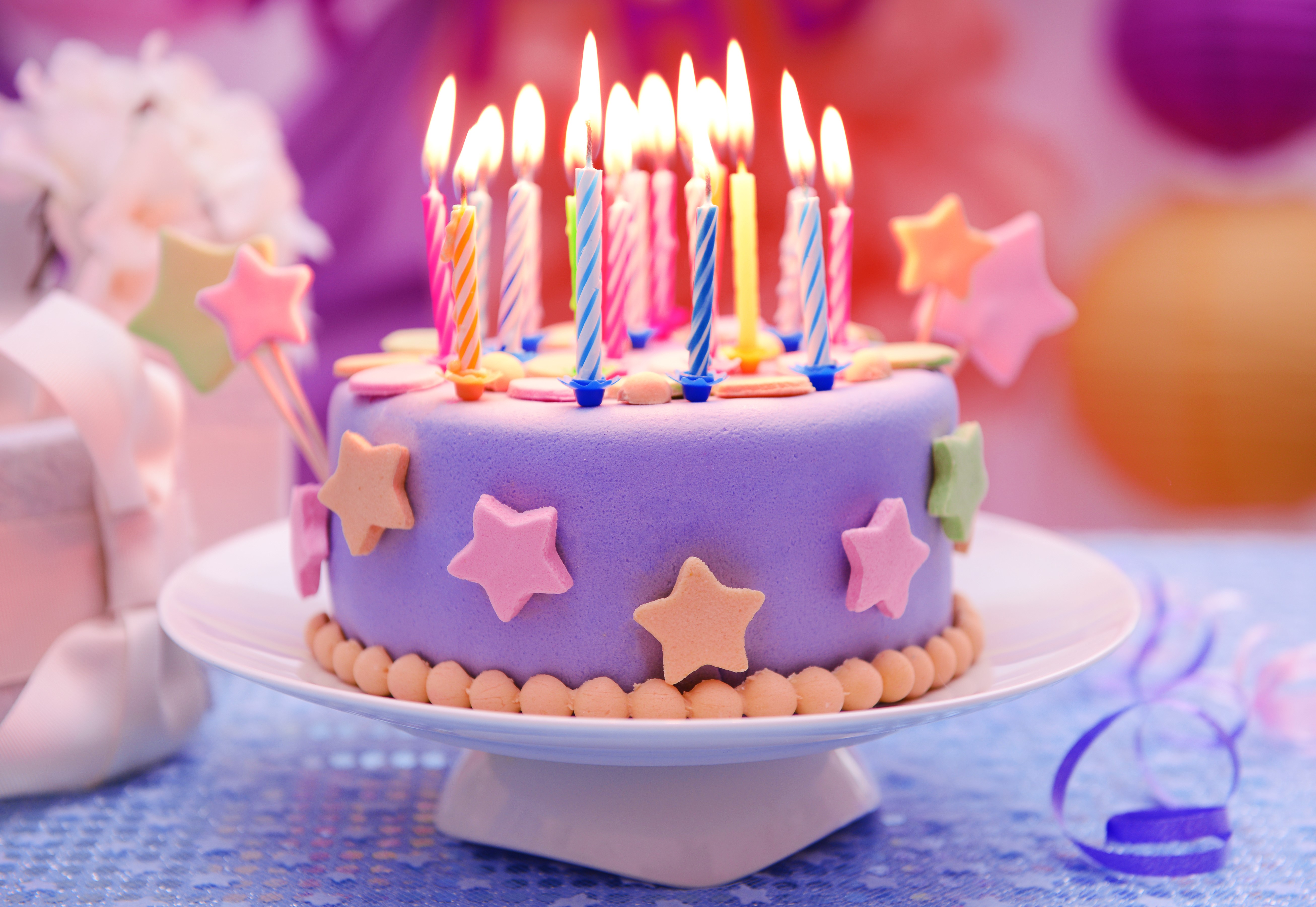 Purple Birthday Cake with Lit Candles and Star Decorations HD Wallpaper