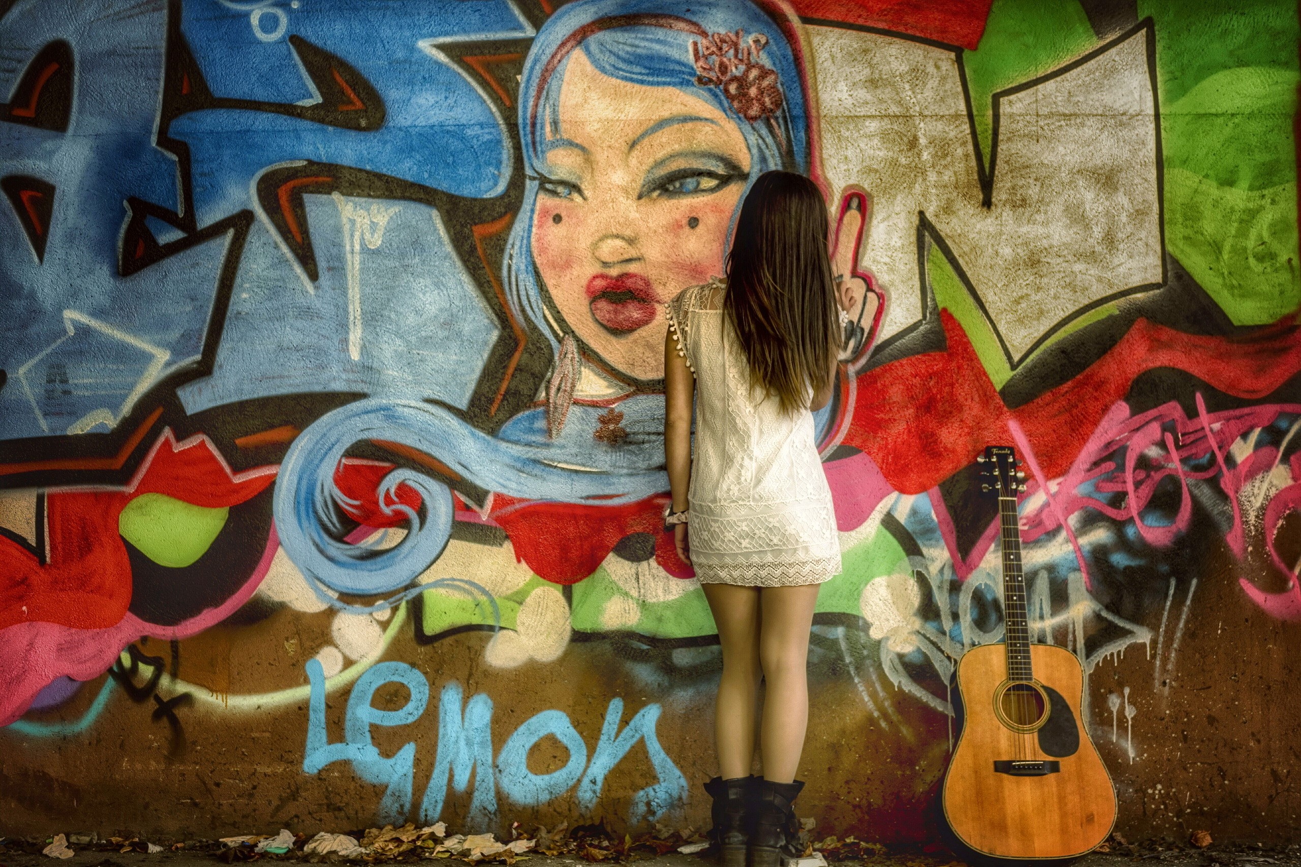 Girl in white dress standing in front of graffiti with guitar HD Wallpaper