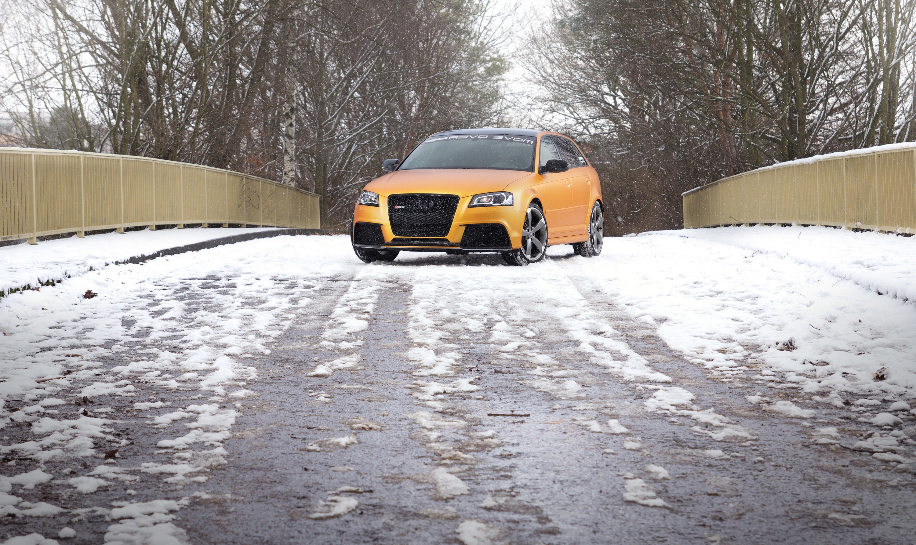 Orange Audi RS3 Sportback on a Snowy Bridge HD Wallpaper