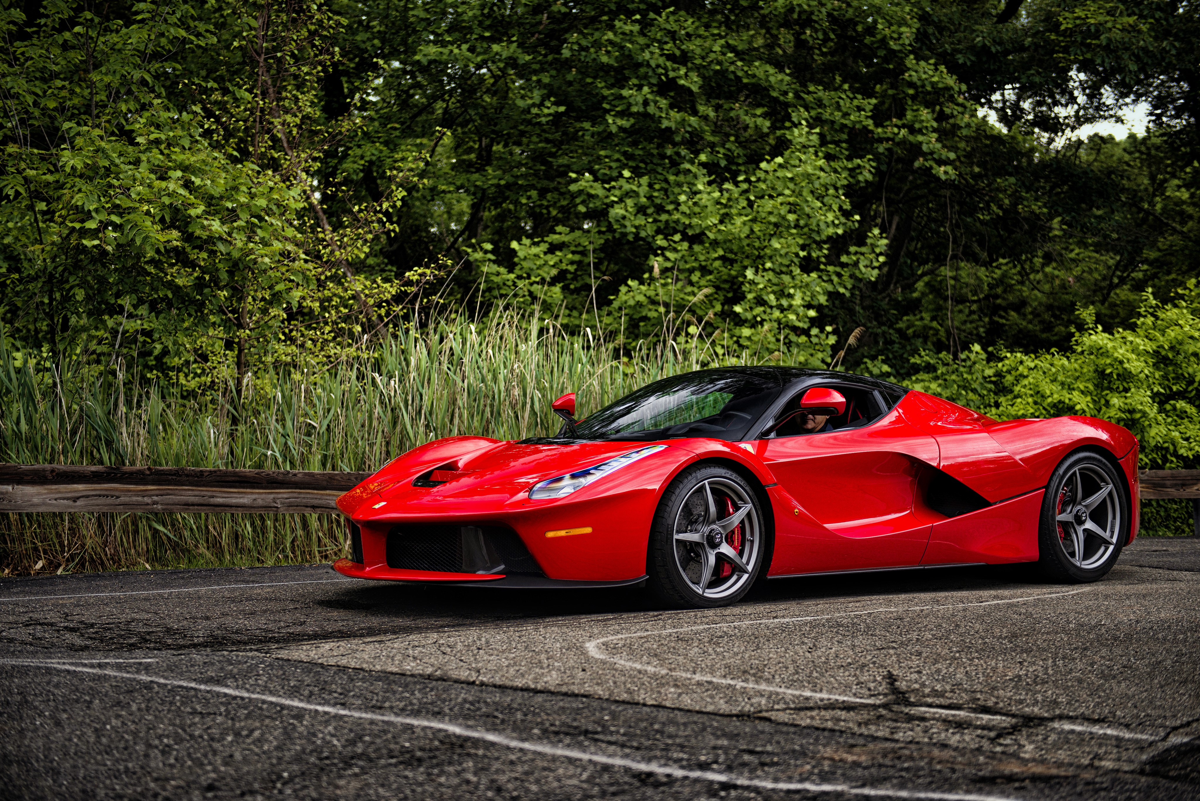 Red Ferrari LaFerrari parked on asphalt road HD Wallpaper