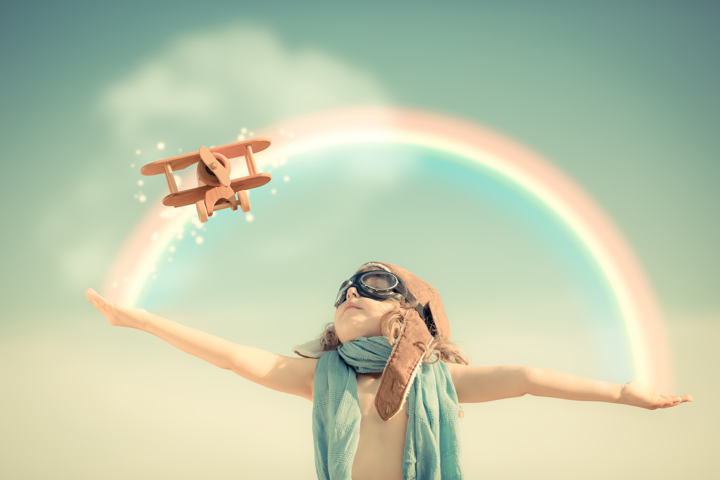 Child with toy airplane and rainbow HD Wallpaper