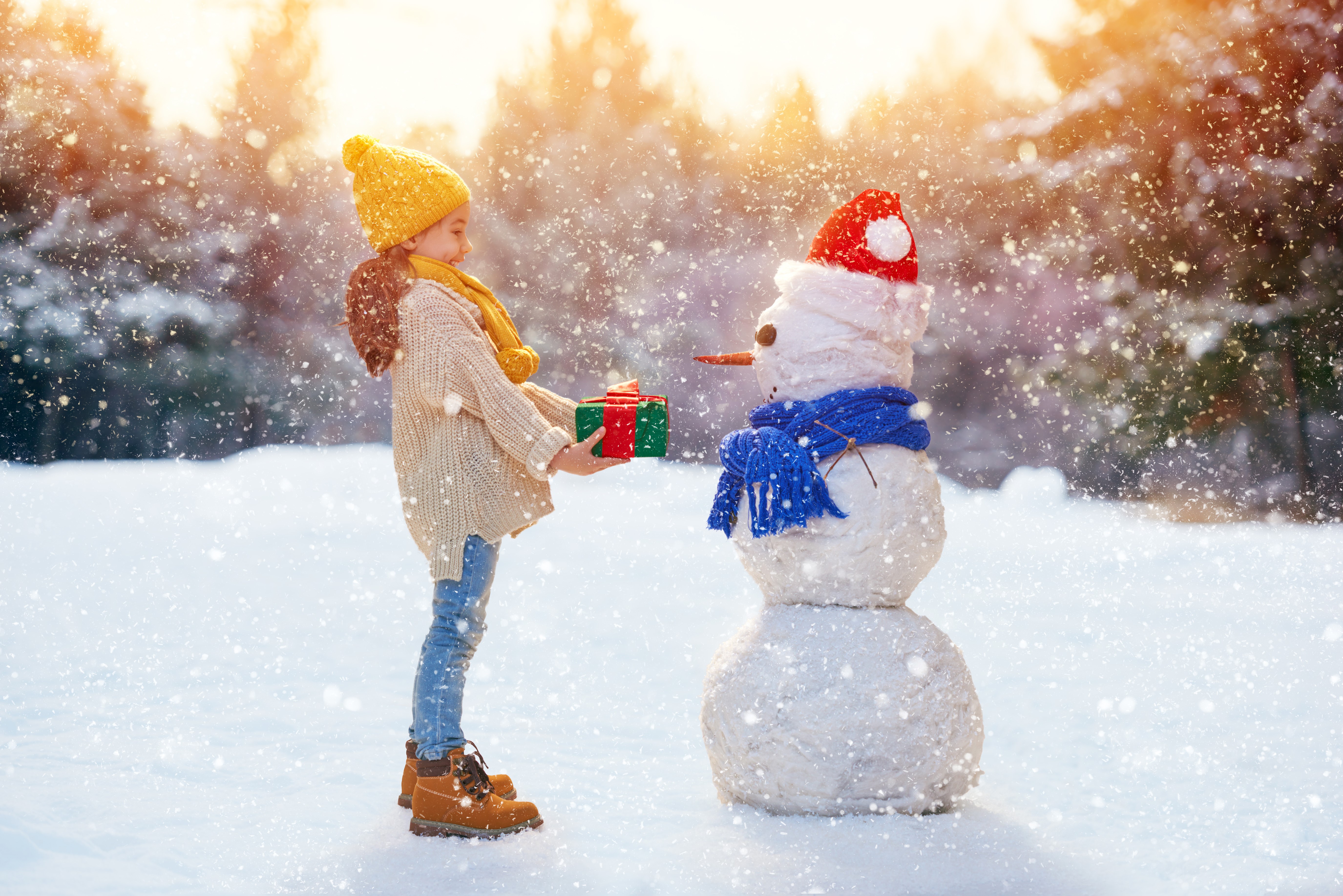 Girl Giving Gift to Snowman in Winter HD Wallpaper