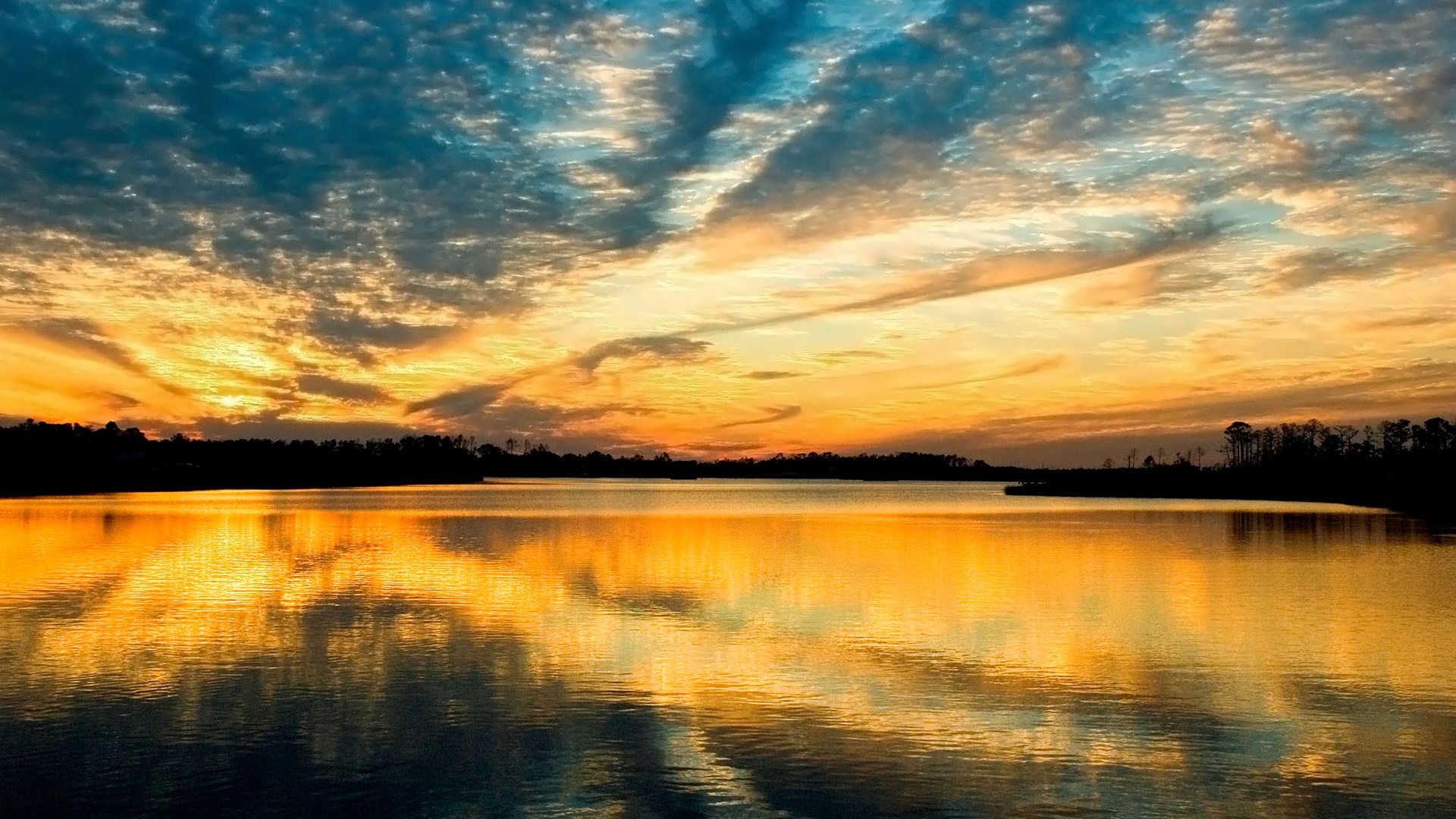 Sunset over a calm lake with colorful clouds HD Wallpaper