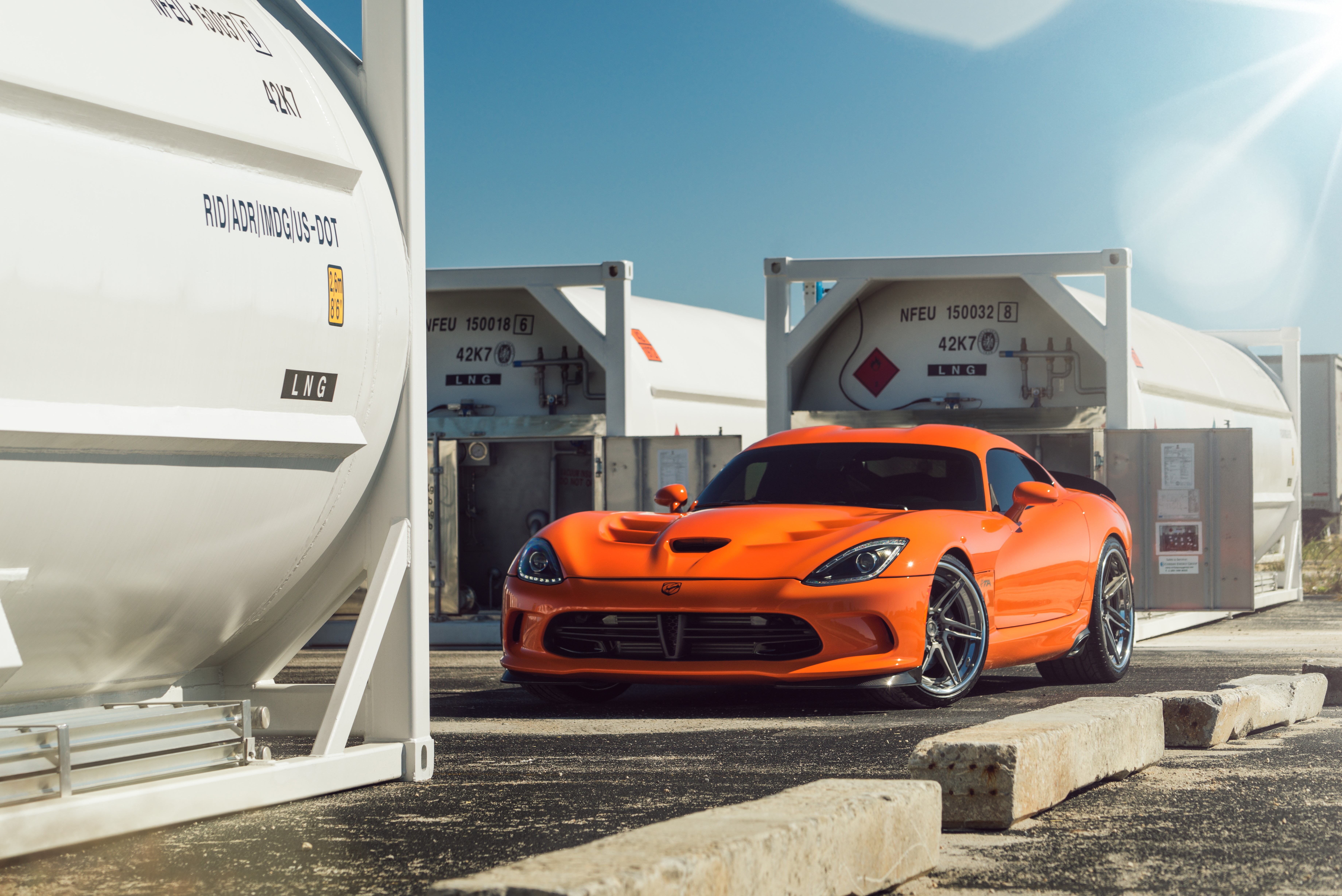 Orange Dodge Viper in front of LNG containers HD Wallpaper