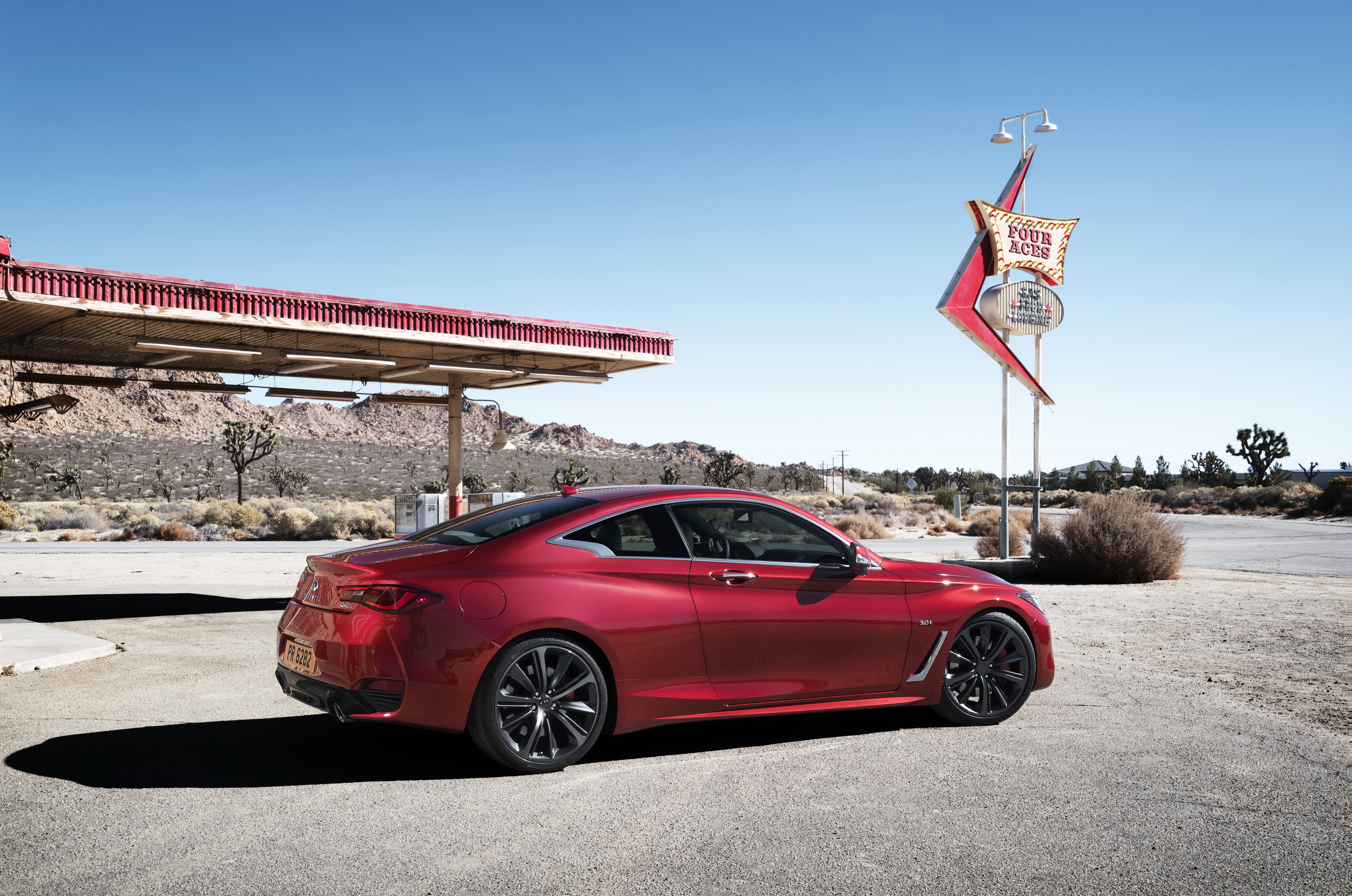 2016 Infiniti Q60 coupe at a desert gas station HD Wallpaper